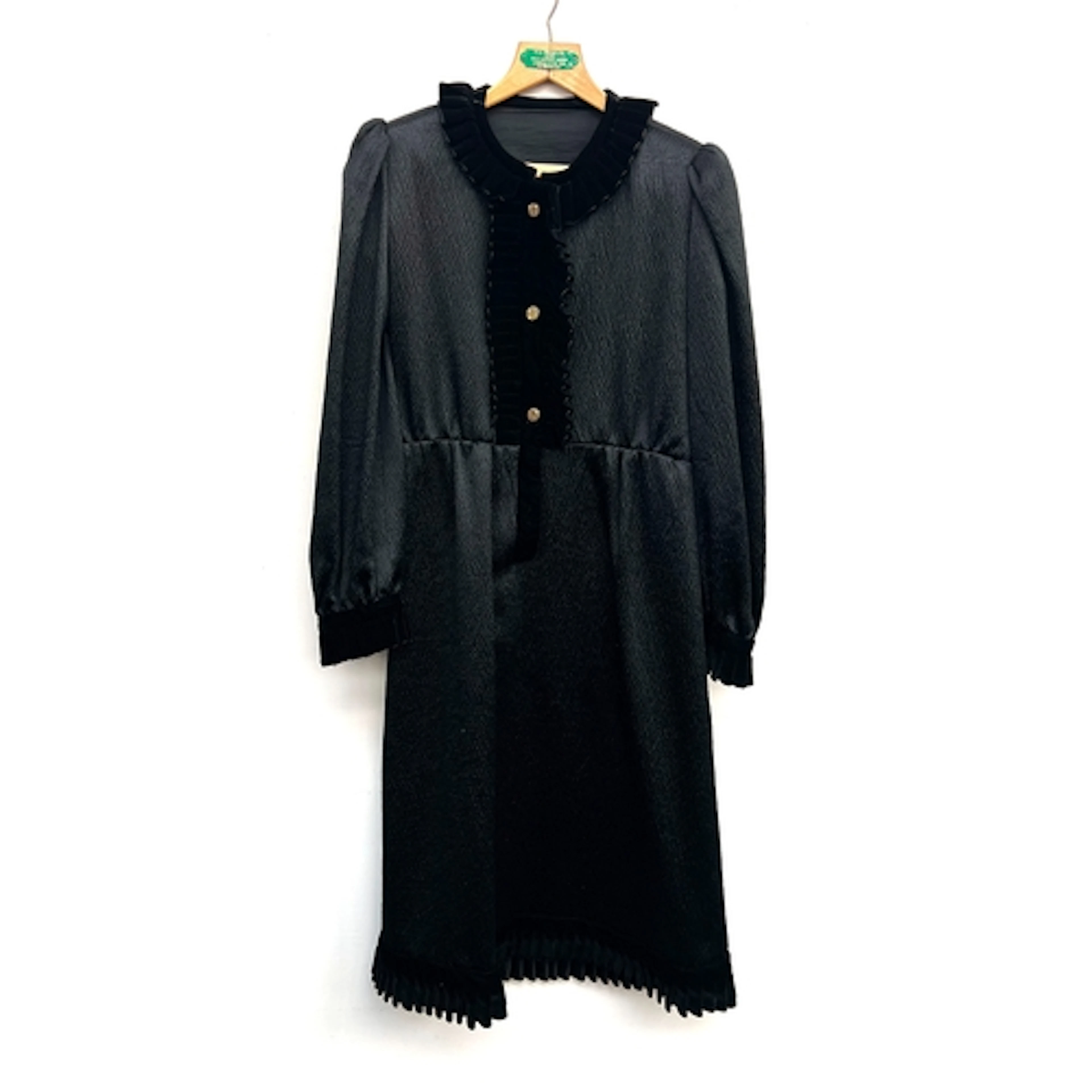 A black silk dress with frilled collar and gilt buttons; tog...
