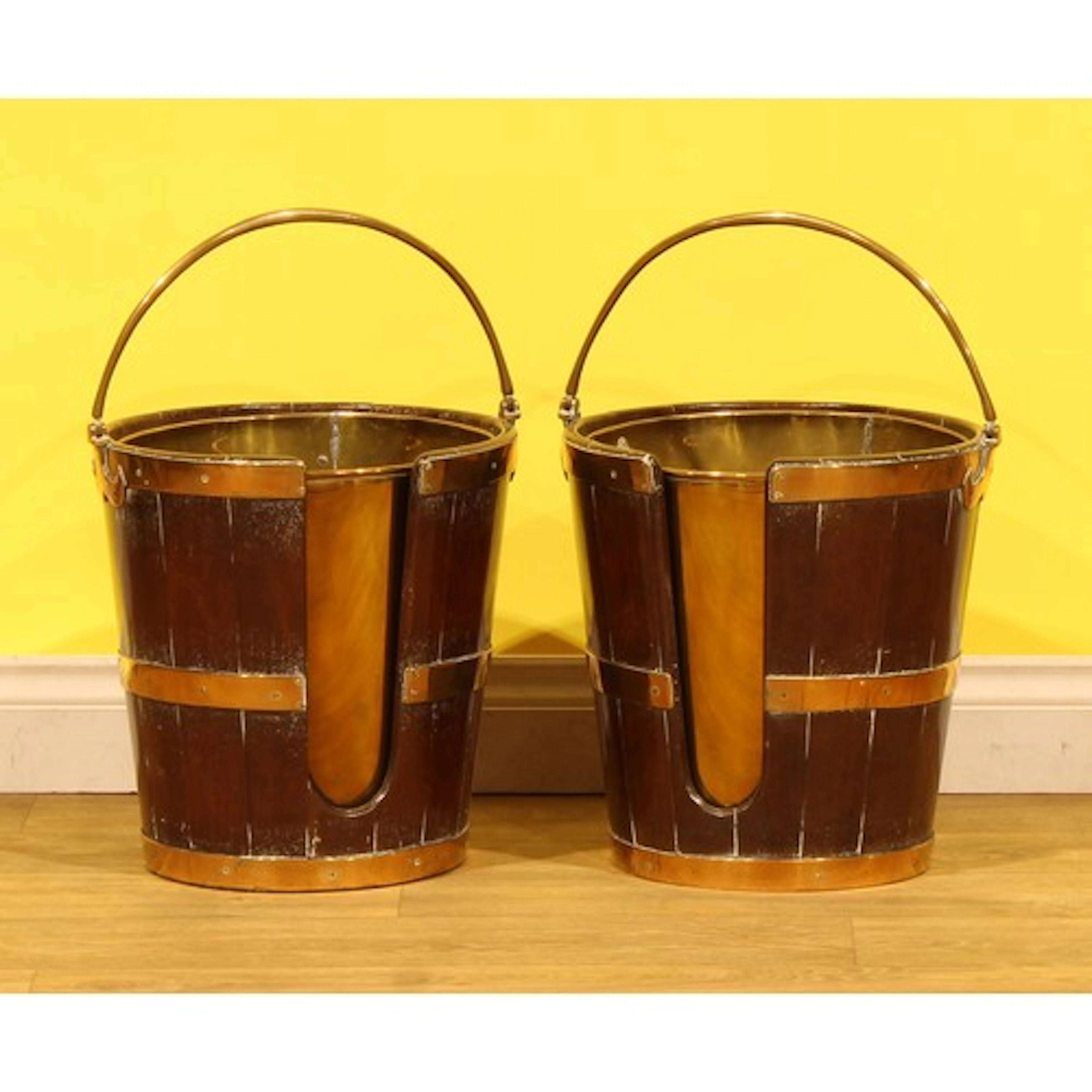 A pair of George III brass bound mahogany plate buckets, pos...