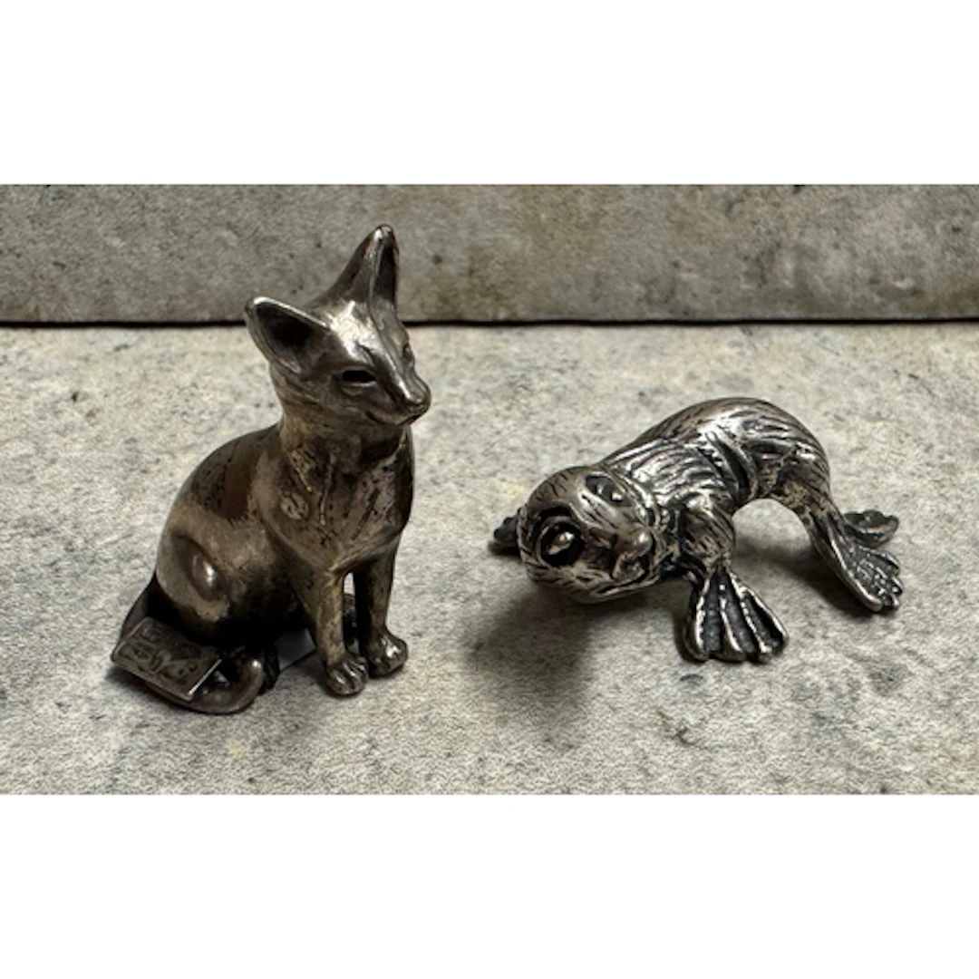 A Continental silver figure of a cat together with another s...