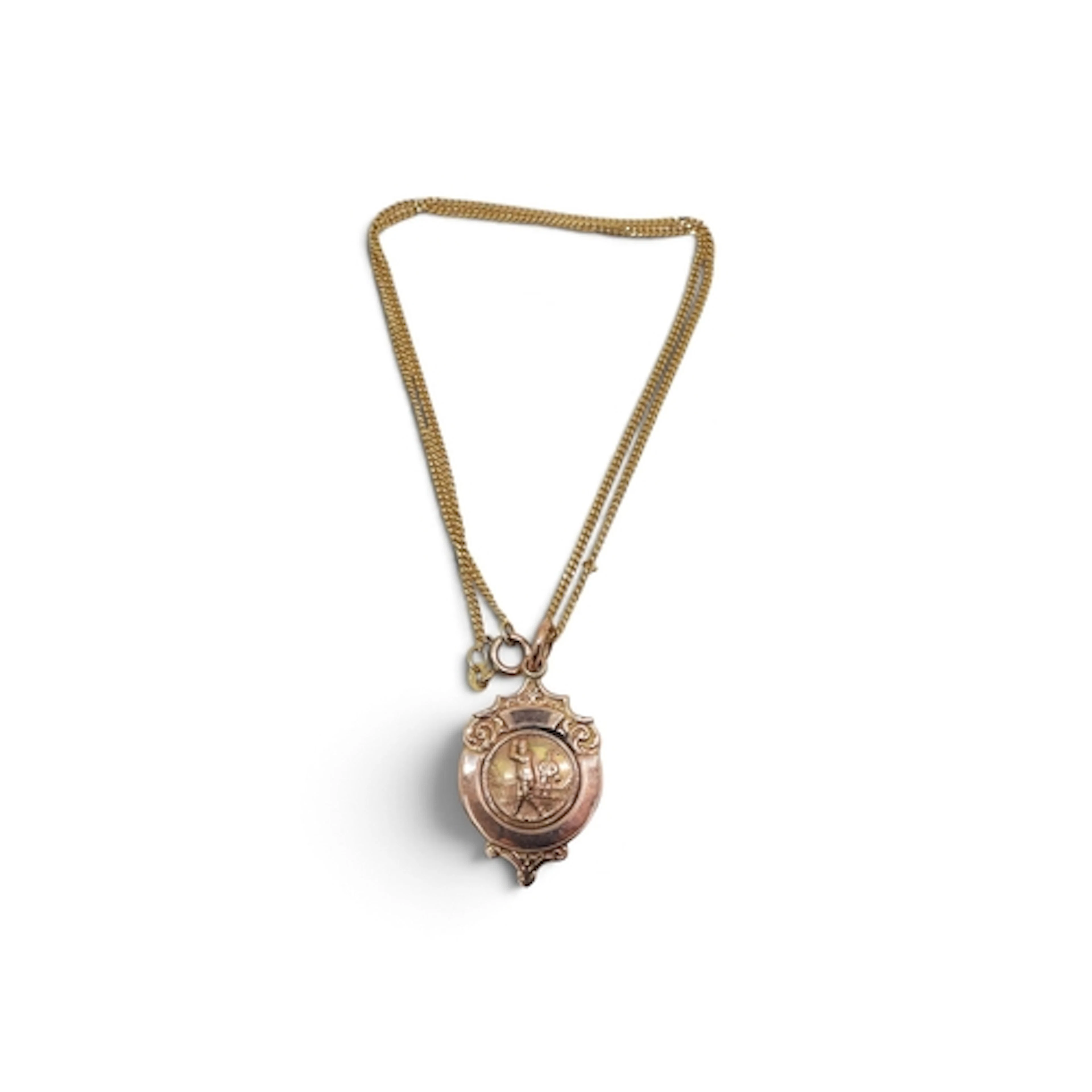 A 9ct rose gold golfing medal on a 9ct gold UnoEArre curb ch...