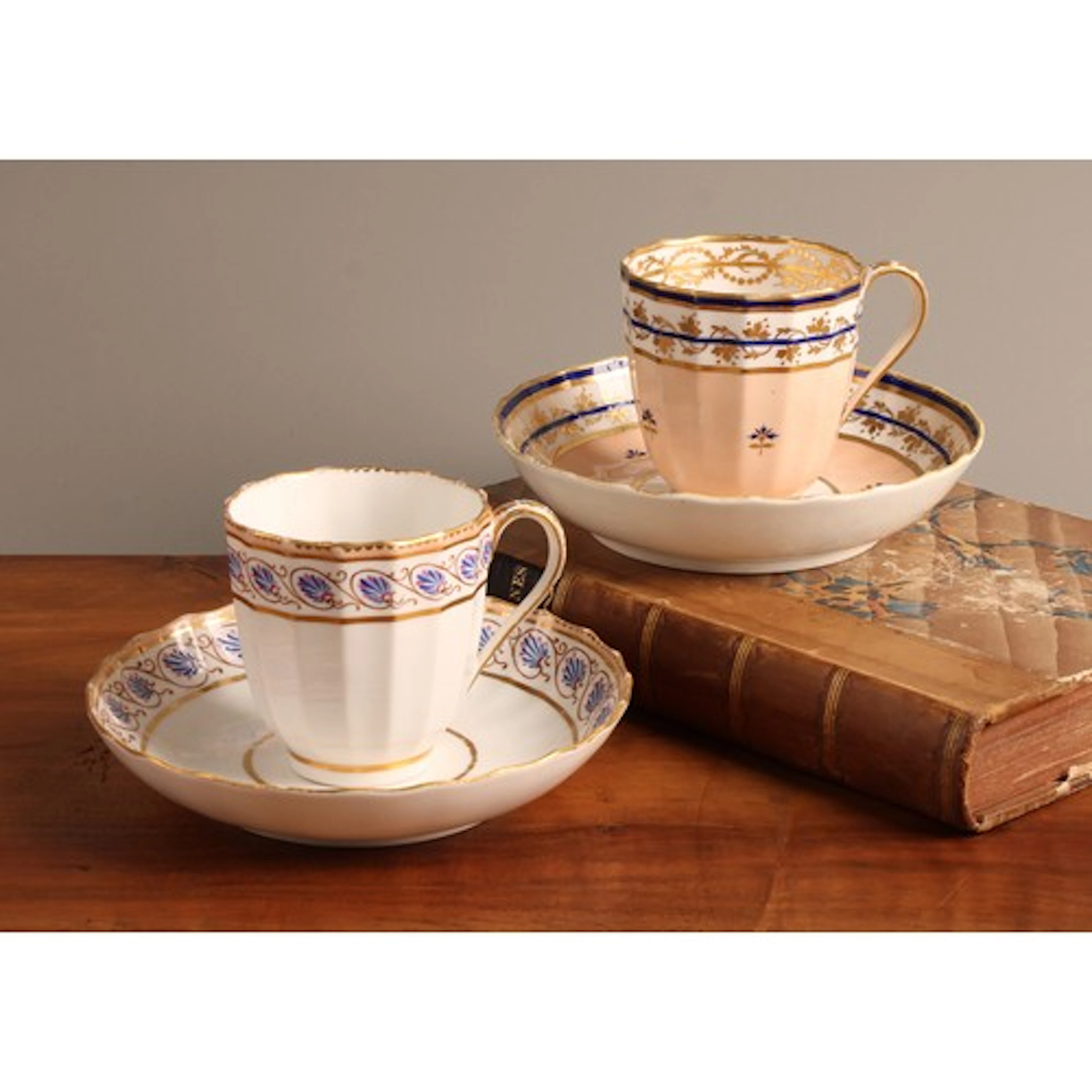 A Derby fluted coffee cup and saucer, decorated with cornflo...