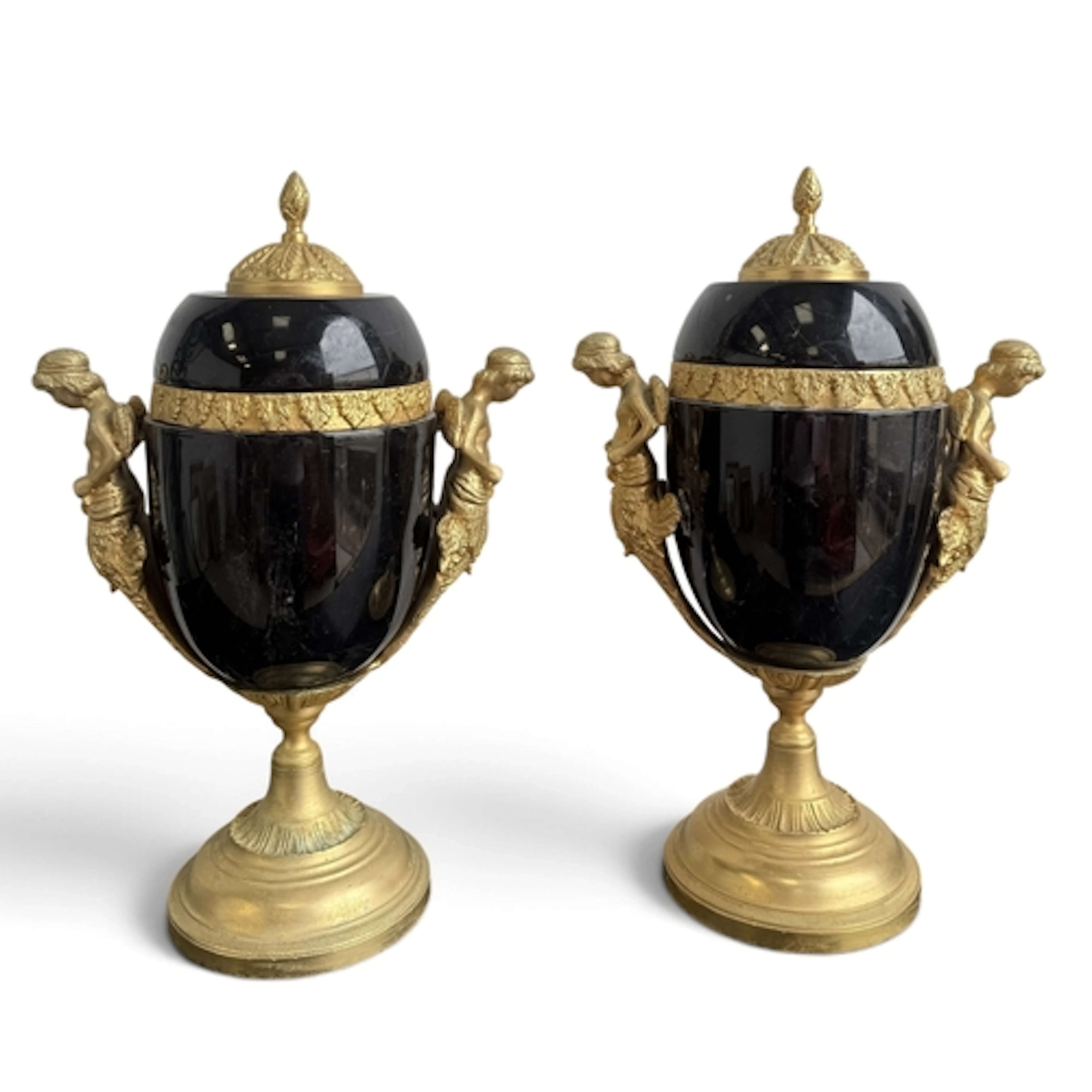 A PAIR OF FOSSIL MARBLE URNS AND COVERS With gilded cherubim...