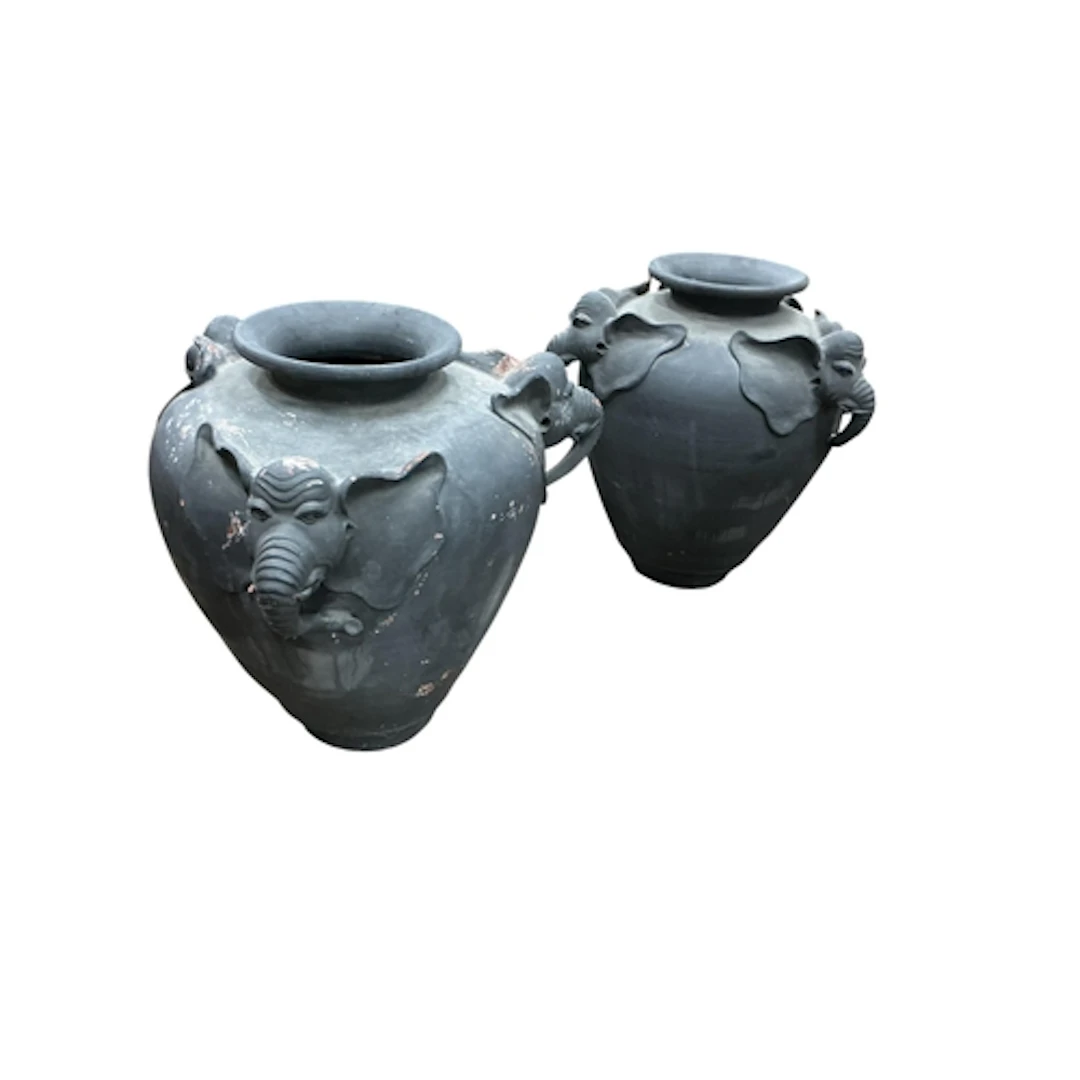A pair of terracotta elephant head garden urns, width 82cm, ...