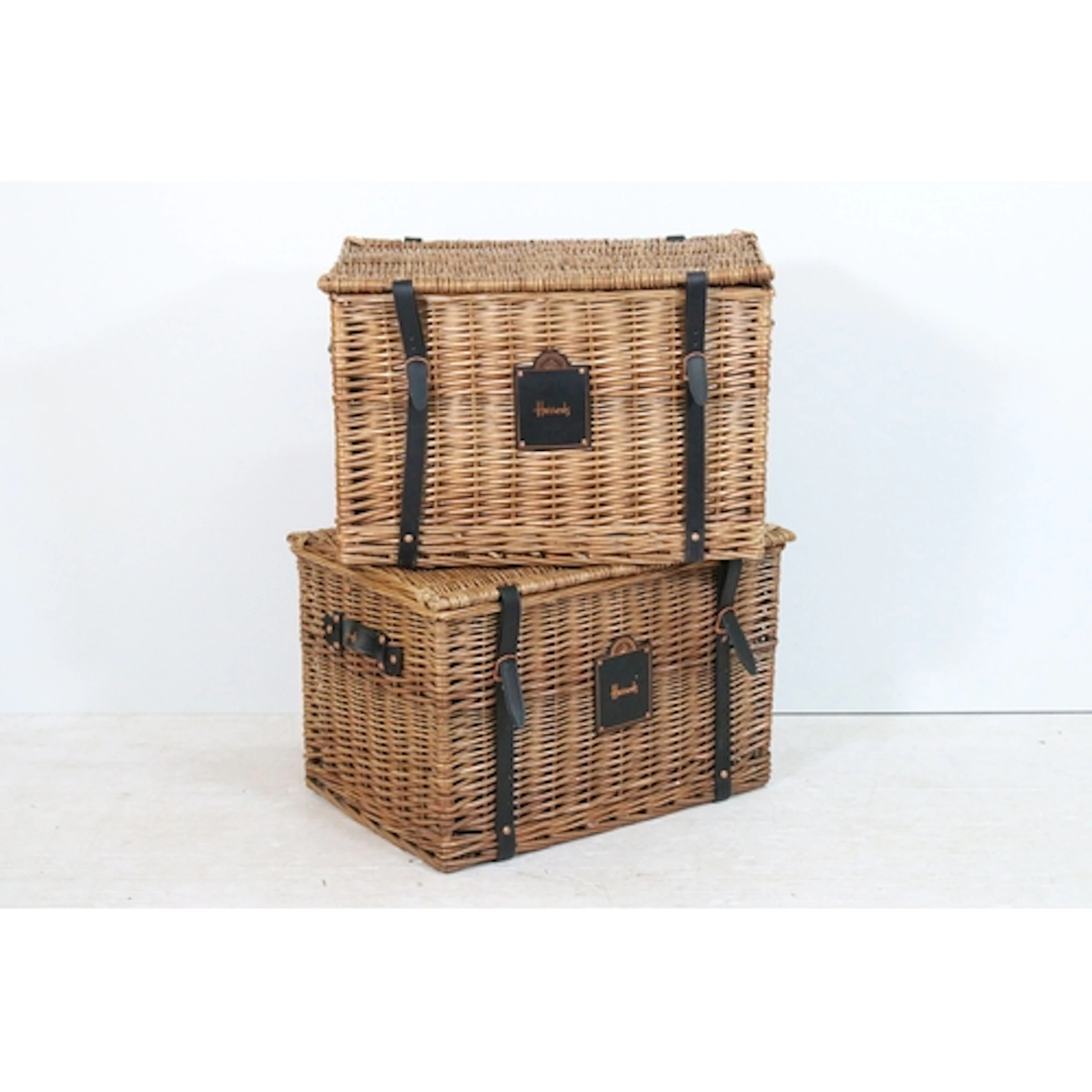 Two Harrods wicker hampers, having leatherette handles and f...