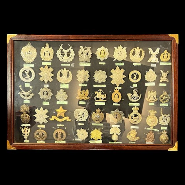 Cap Badges, a framed collection of mostly Scottish cap badge...