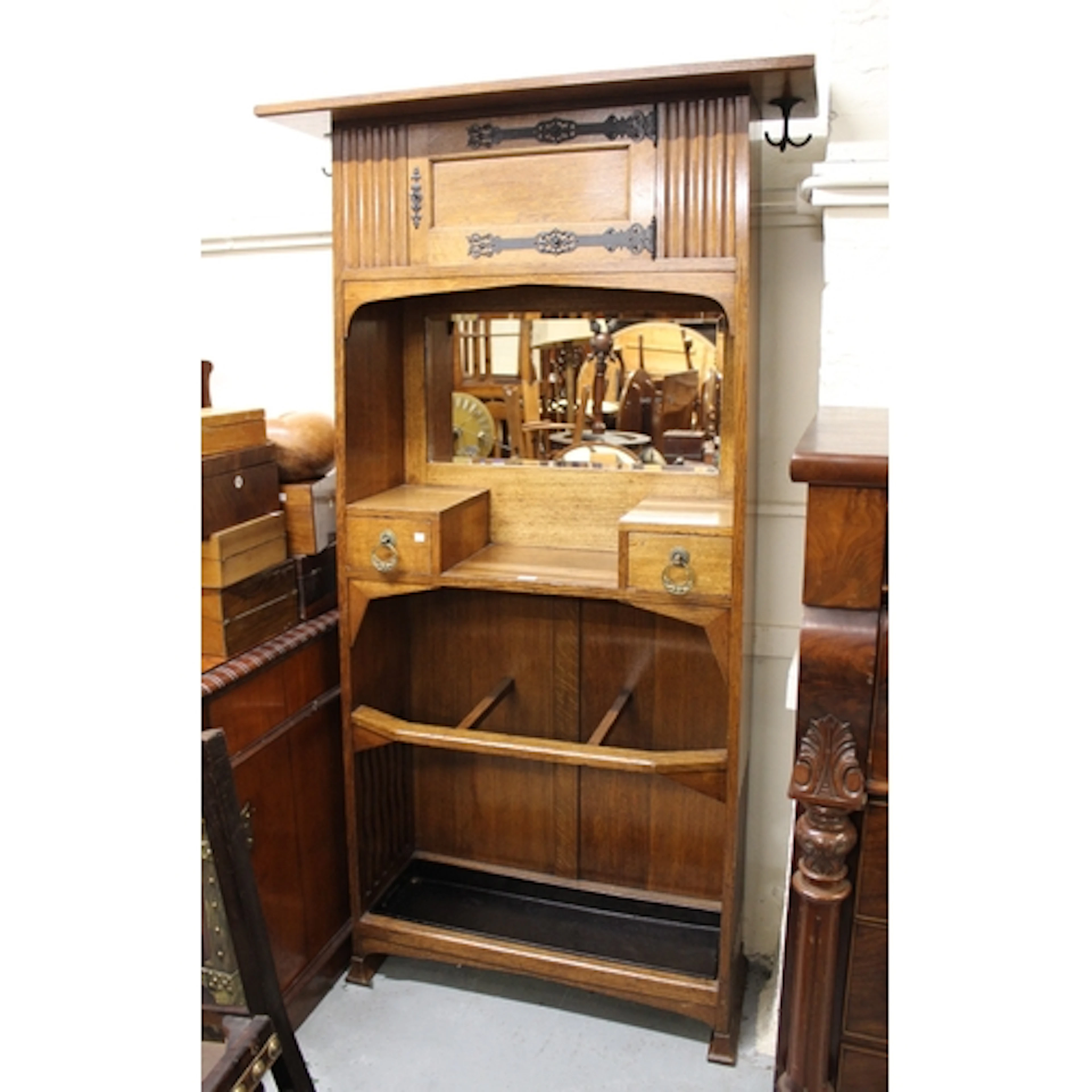 Arts and Crafts oak hall stand of Liberty type with a small ...