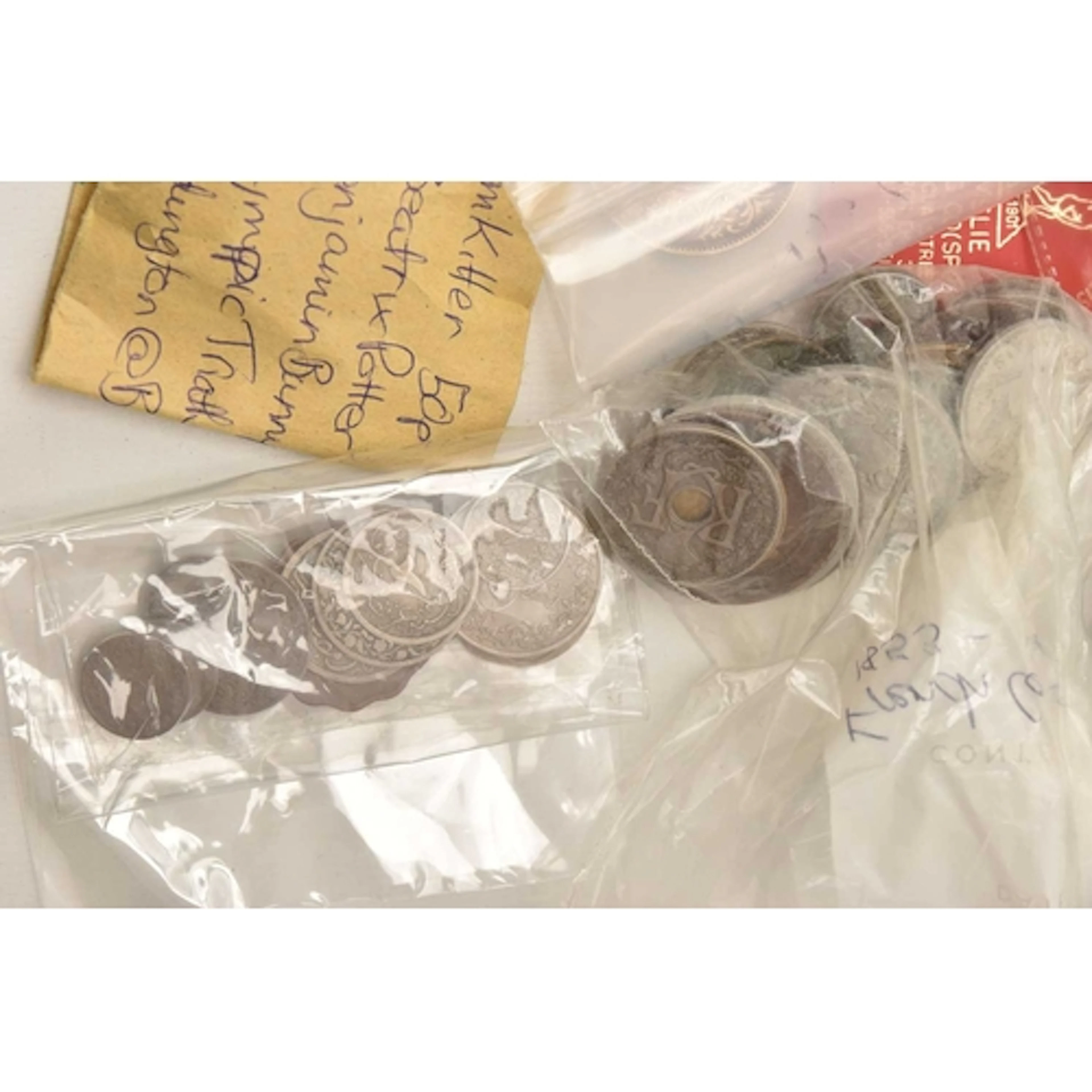 A BAG CONTAINING 18 QEII CROWNS UNC, a paper envelope con...