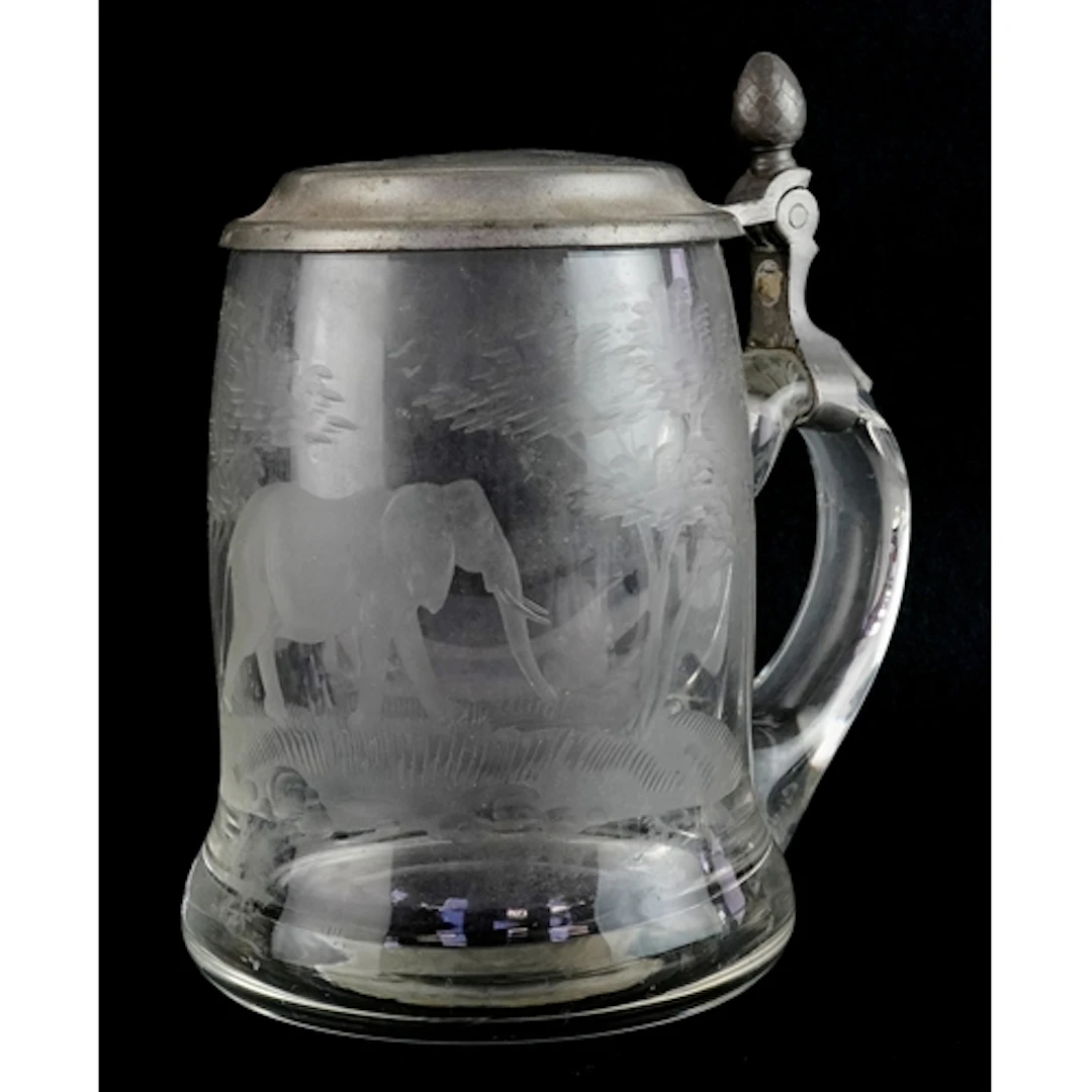 Antique glass stein acid etched with an elephant amongst tre...