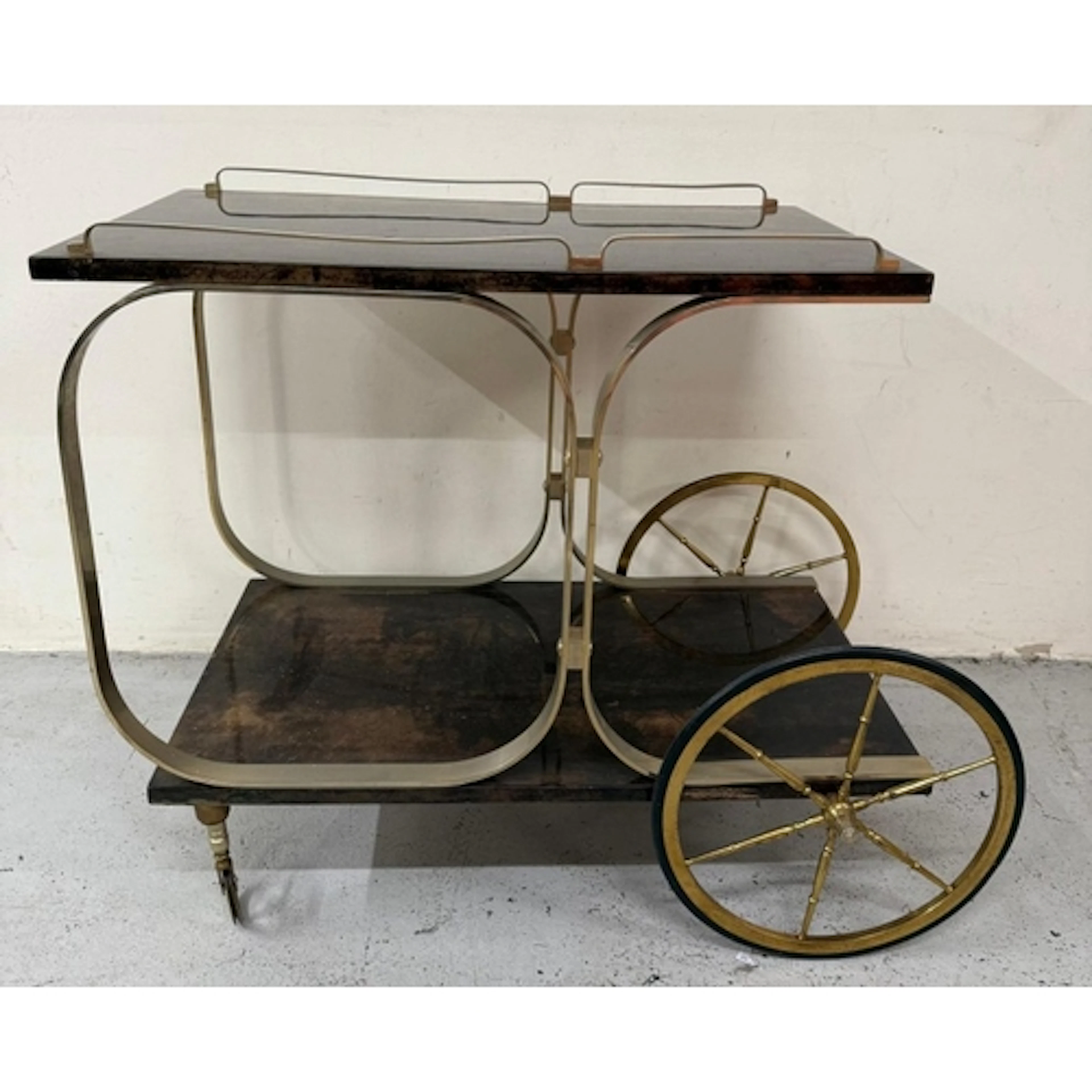 An Aldo Tura Goatskin brass loop bar trolly on cart wheel ef...