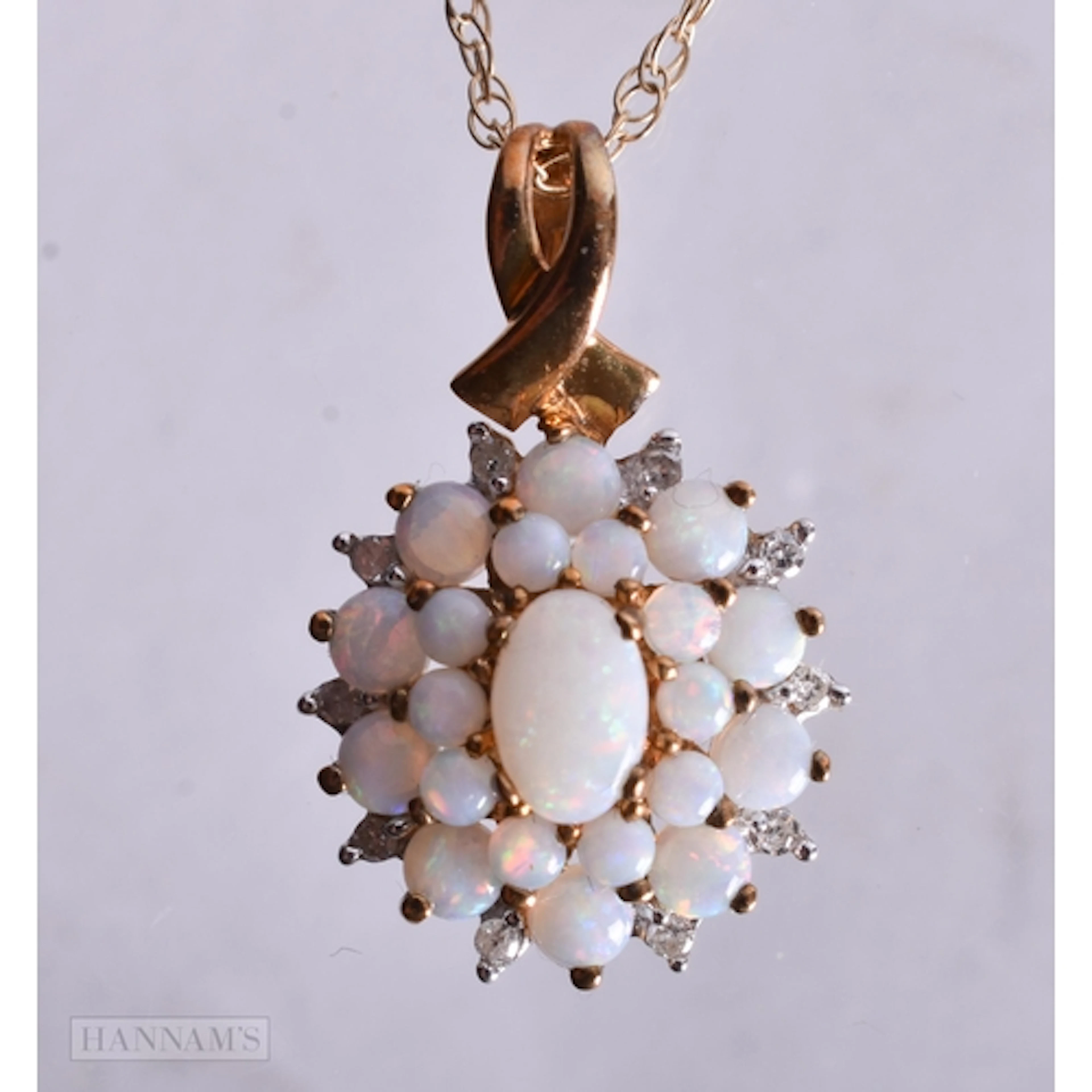 9ct opal and diamond cluster set pendant (2.7g). 46 cm long.