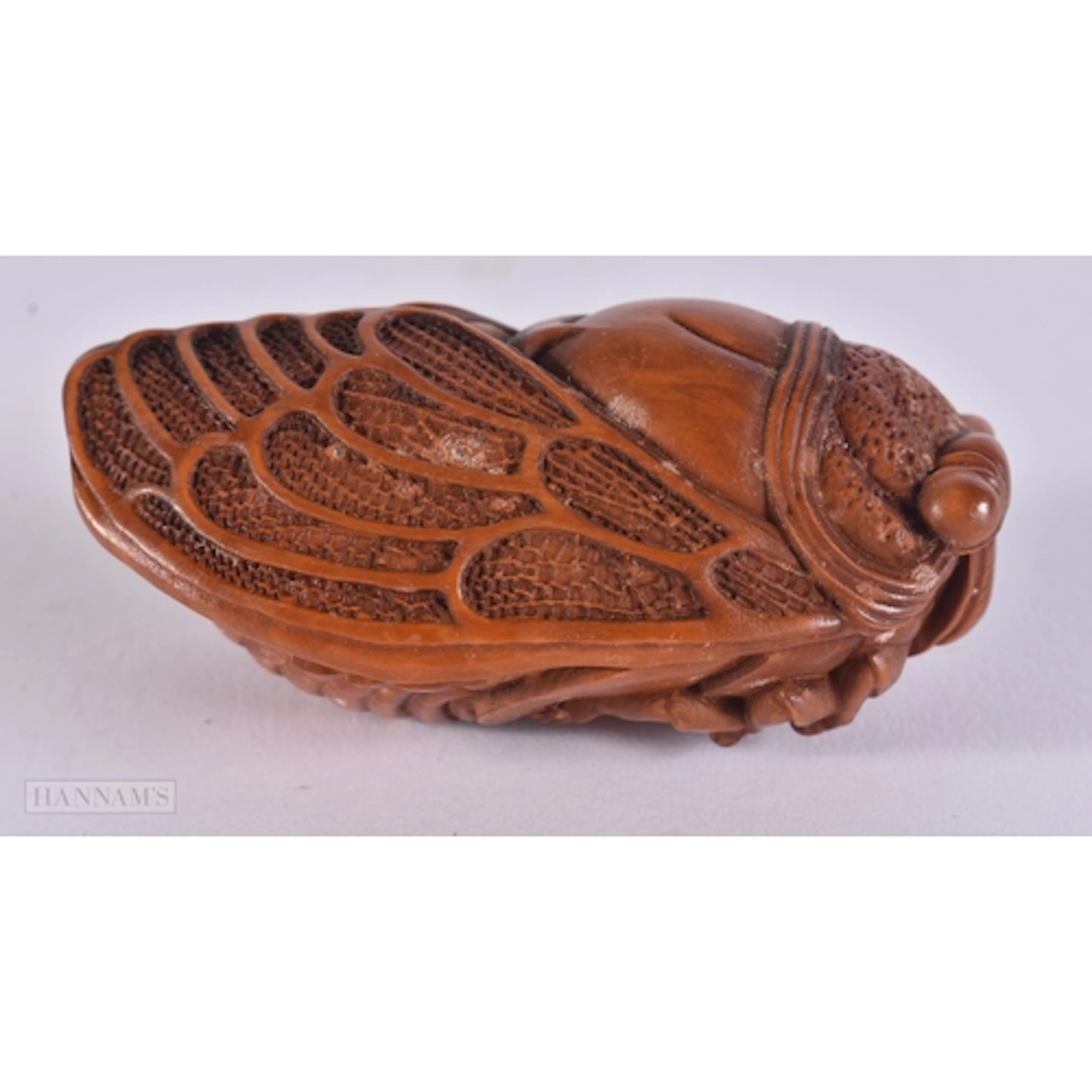 A CARVED WOOD CICADA. 3.1 x 3.8 x 6.9 cm.