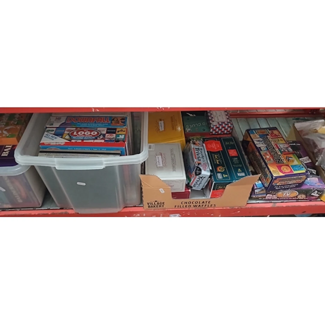 A shelf containing a large collection of assorted board & qu...