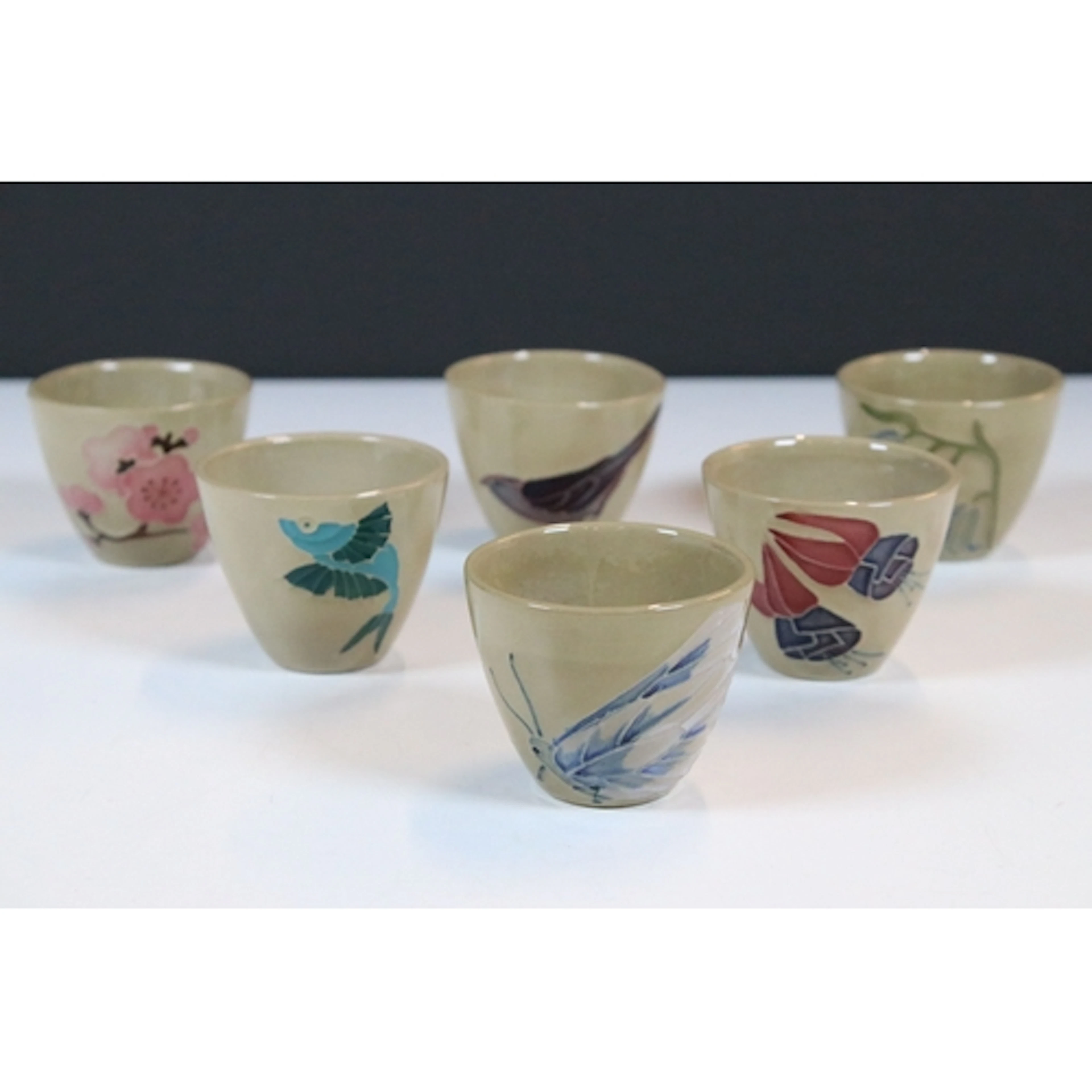 Set of six Moorcroft saki or sake cups, in varying designs, ...