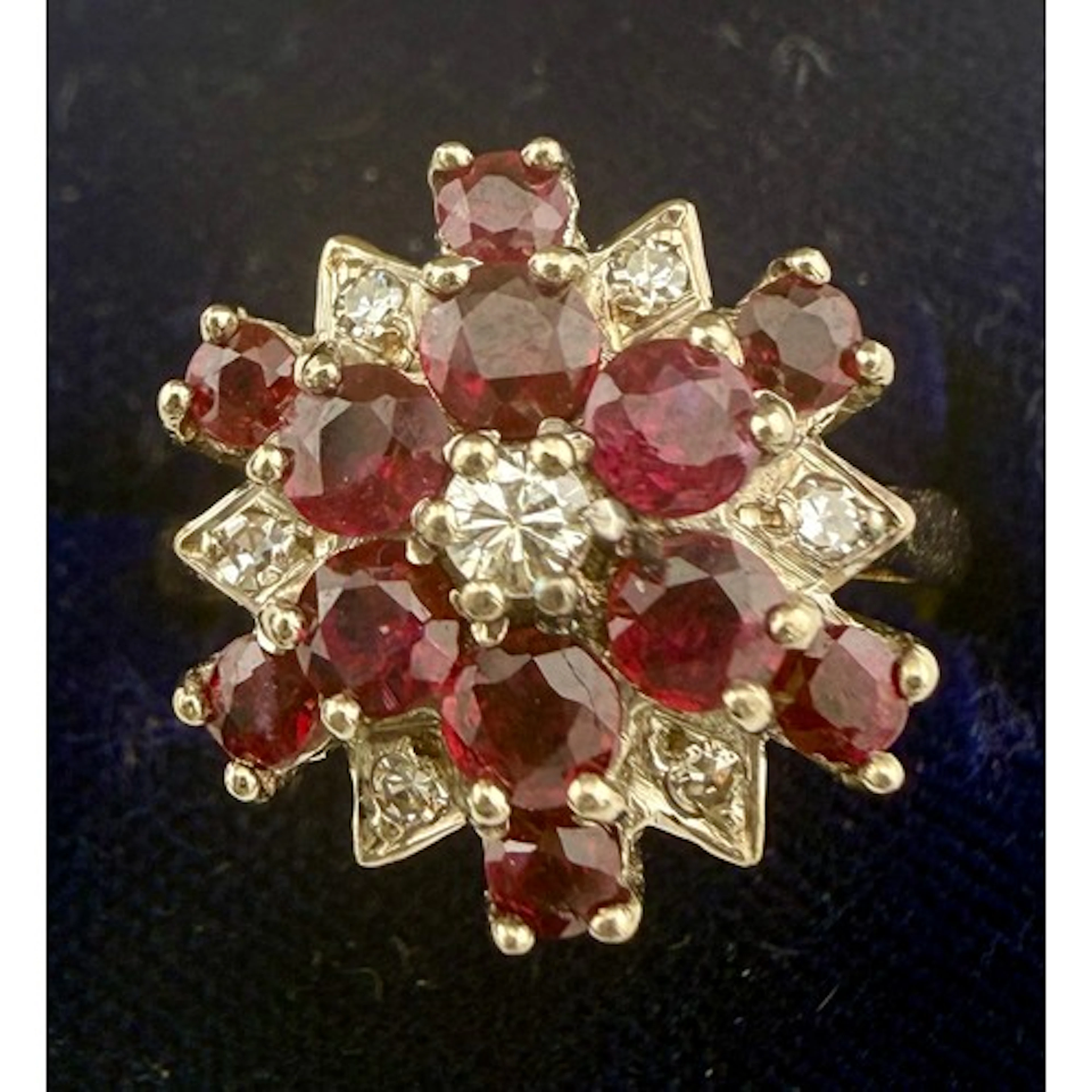 An 18 carat gold cluster ring set with diamonds and rubies. ...