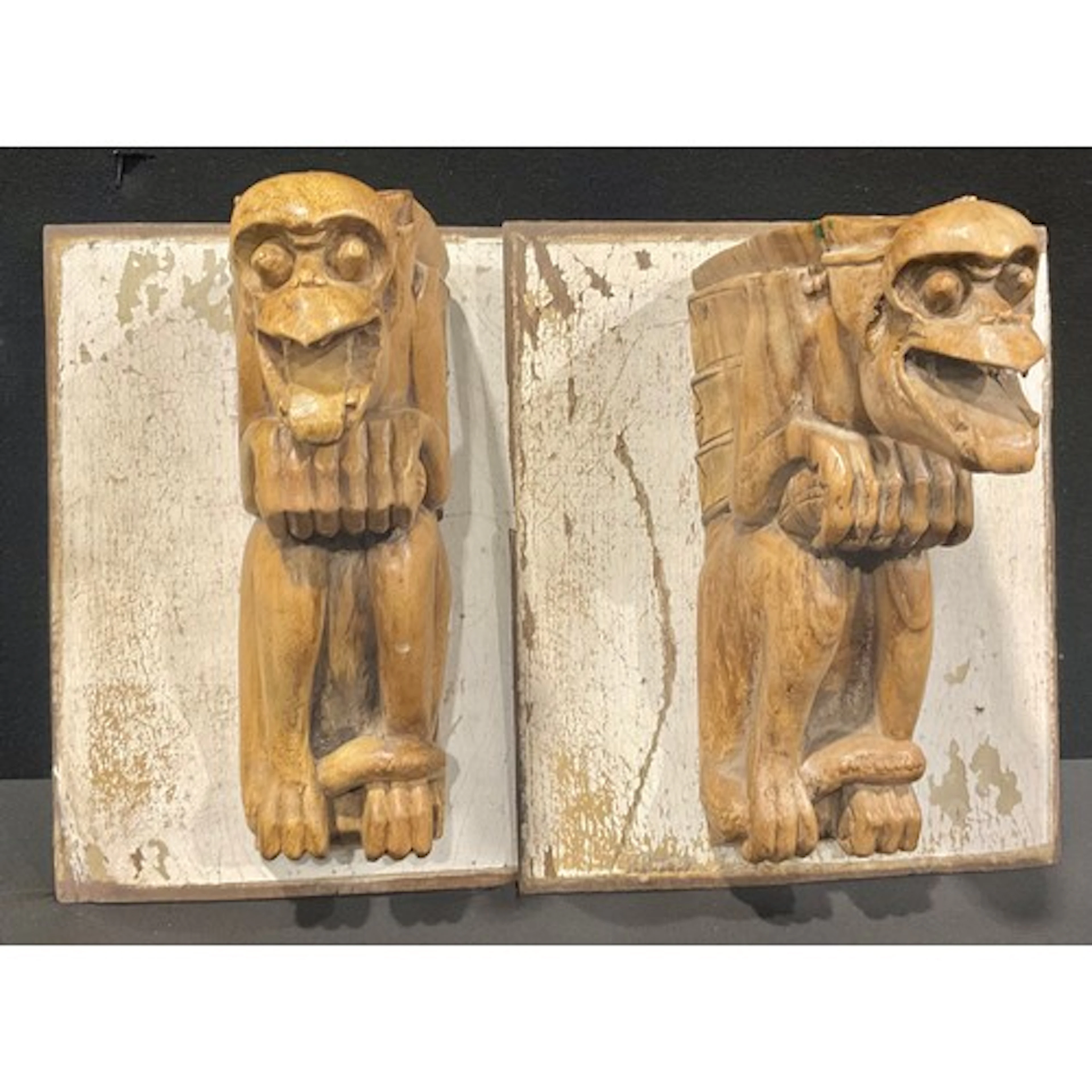 A pair of Gothic style carved softwood grotesques, each moun...