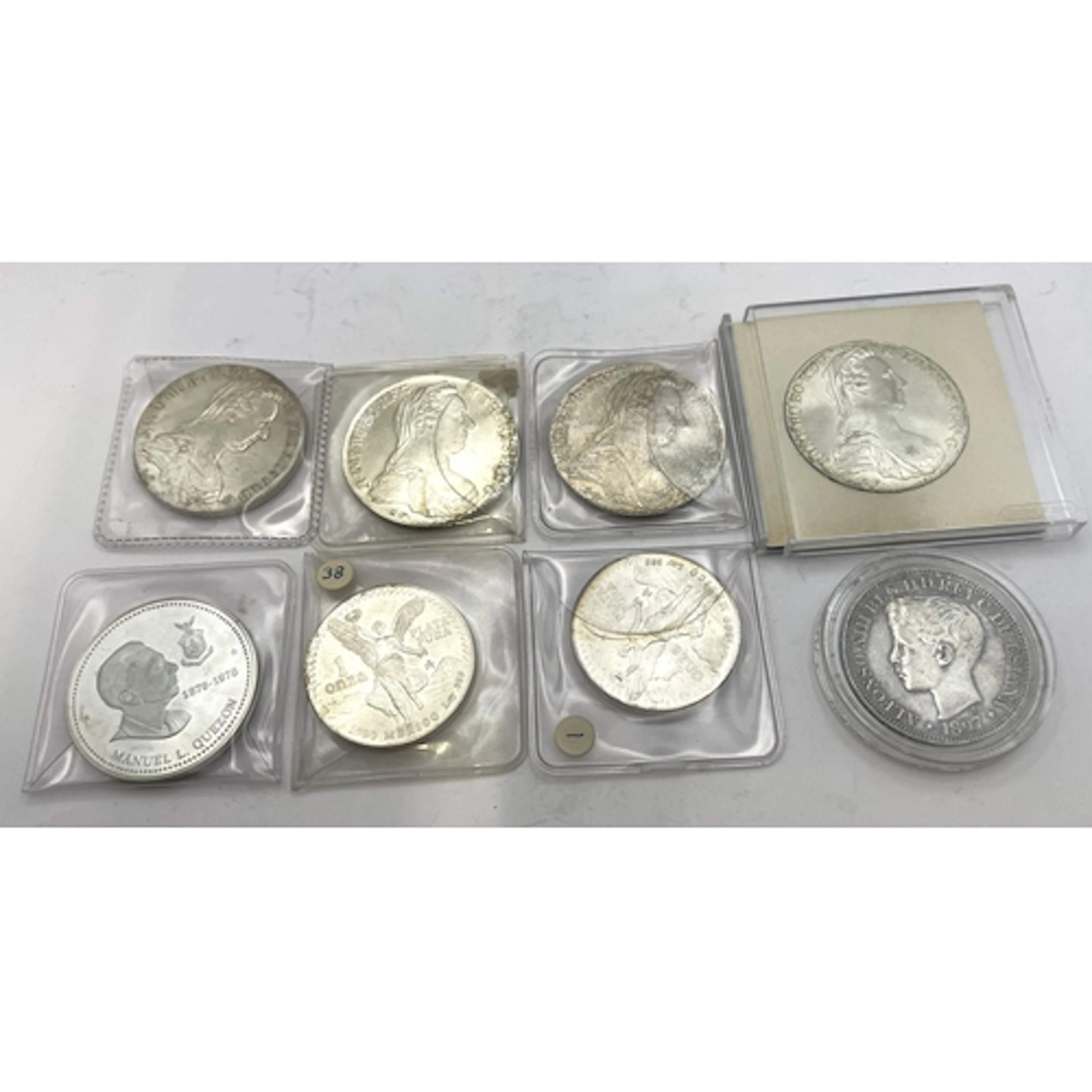 A collection of silver coins to include 4 Maria Theresa Tale...