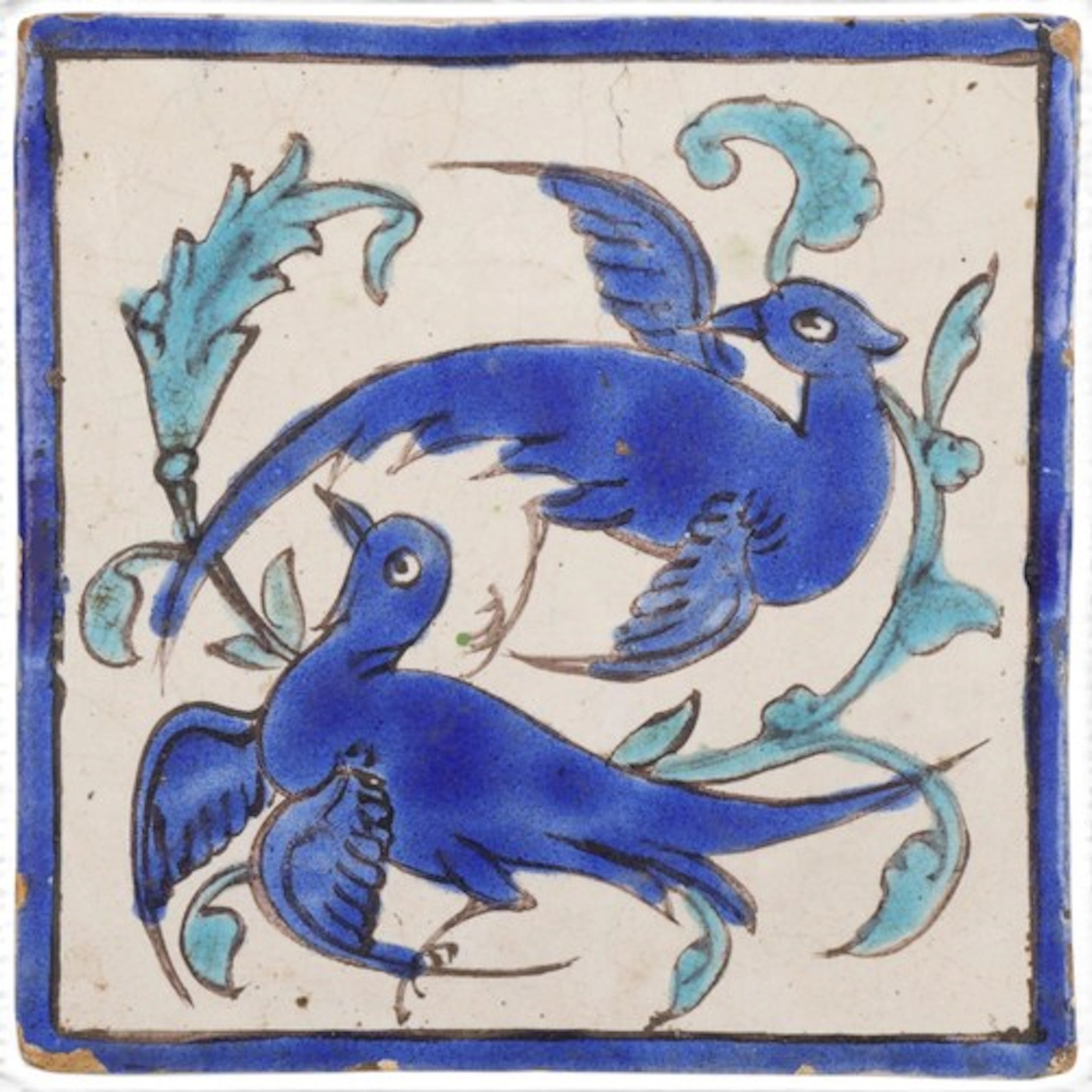 An Antique Persian blue and white ceramic tile with hand pai...