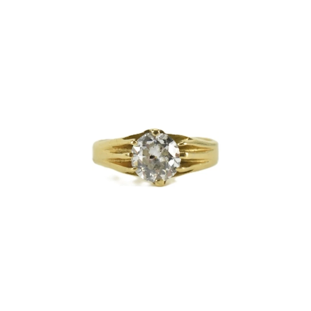 A mid 20th century solitaire diamond and yellow metal ring, ...