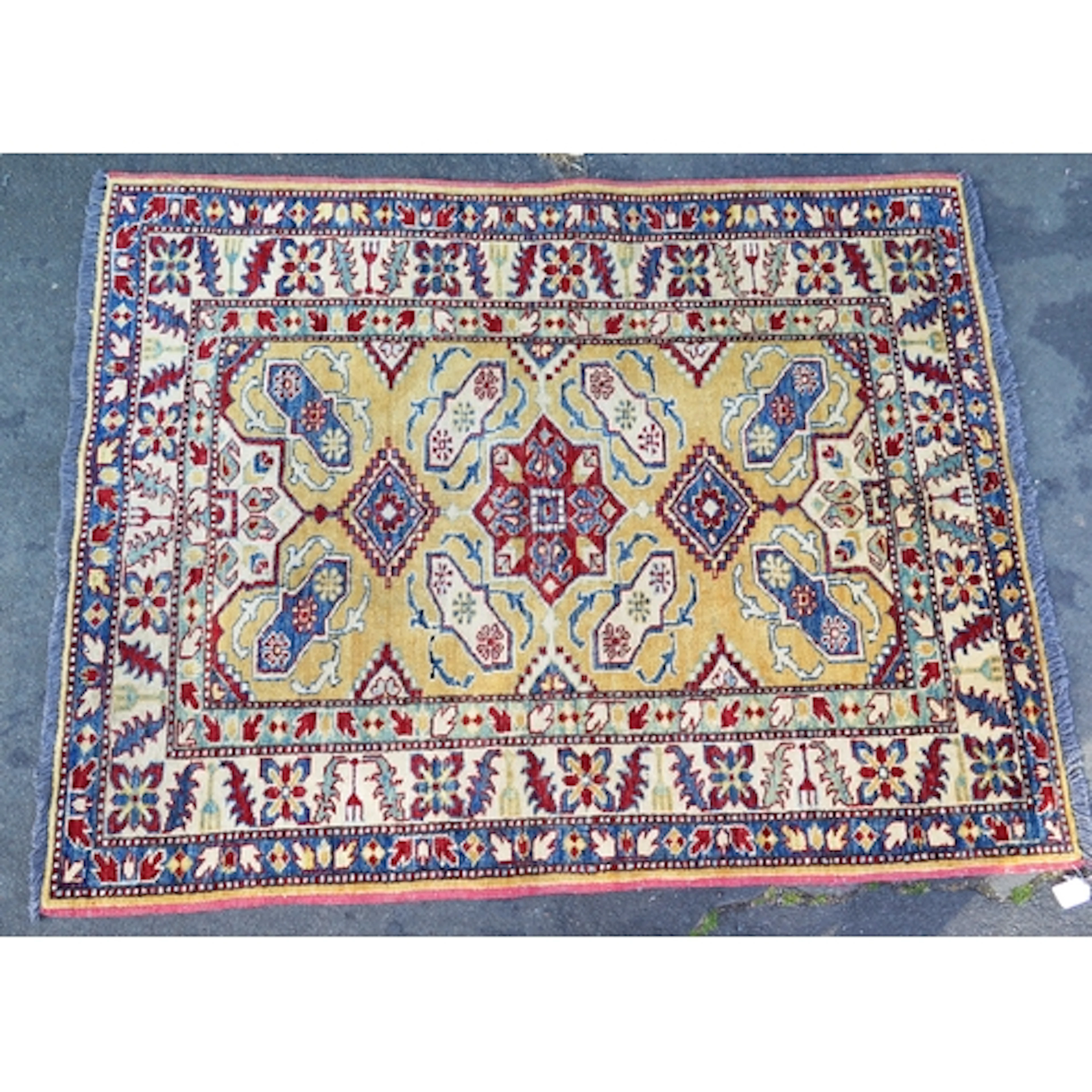 A Pakistan rug, the lemon yellow field with central stellar ...