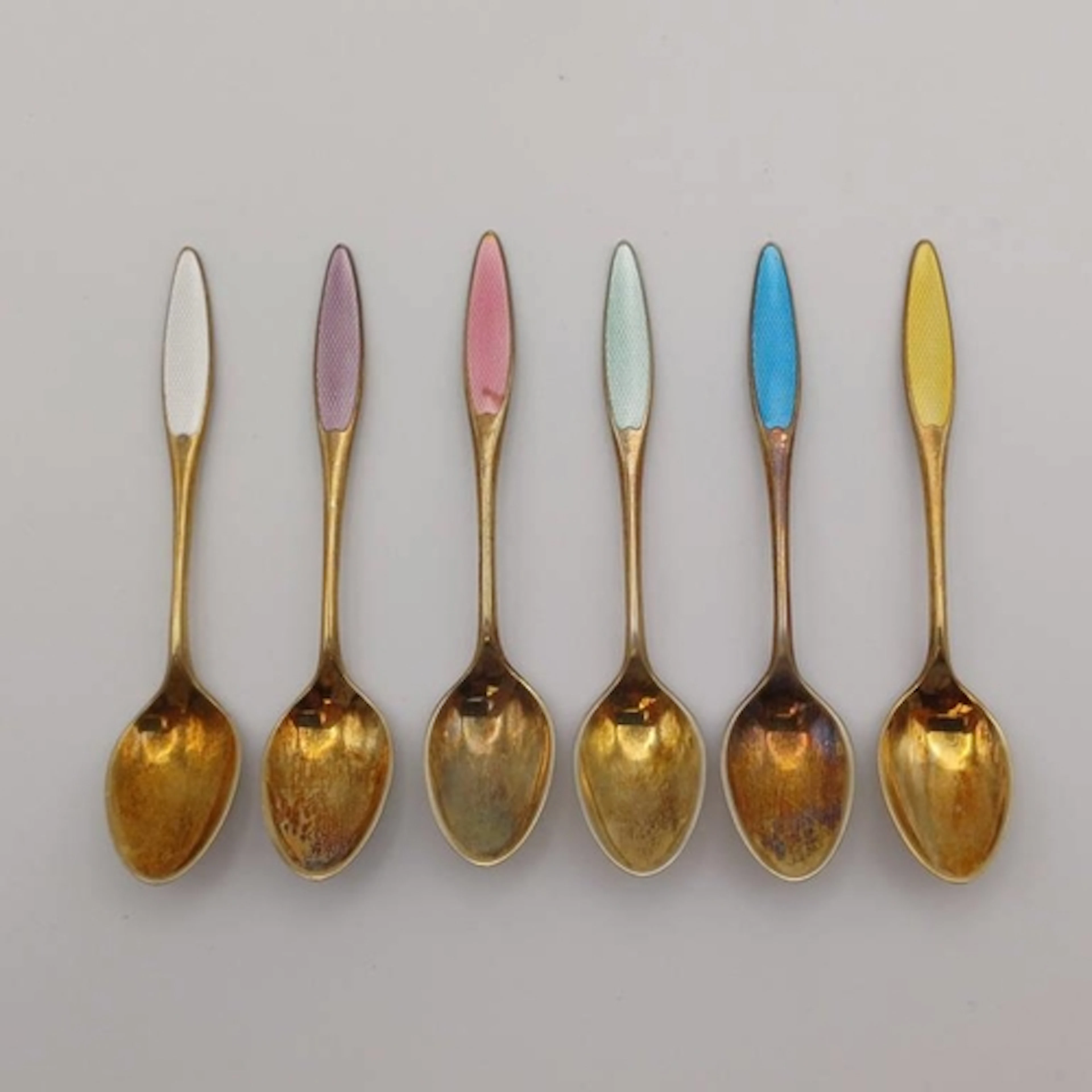 A SET OF 6 DANISH SILVER-GILT ENAMEL COFFEE SPOONS MARKED FR...
