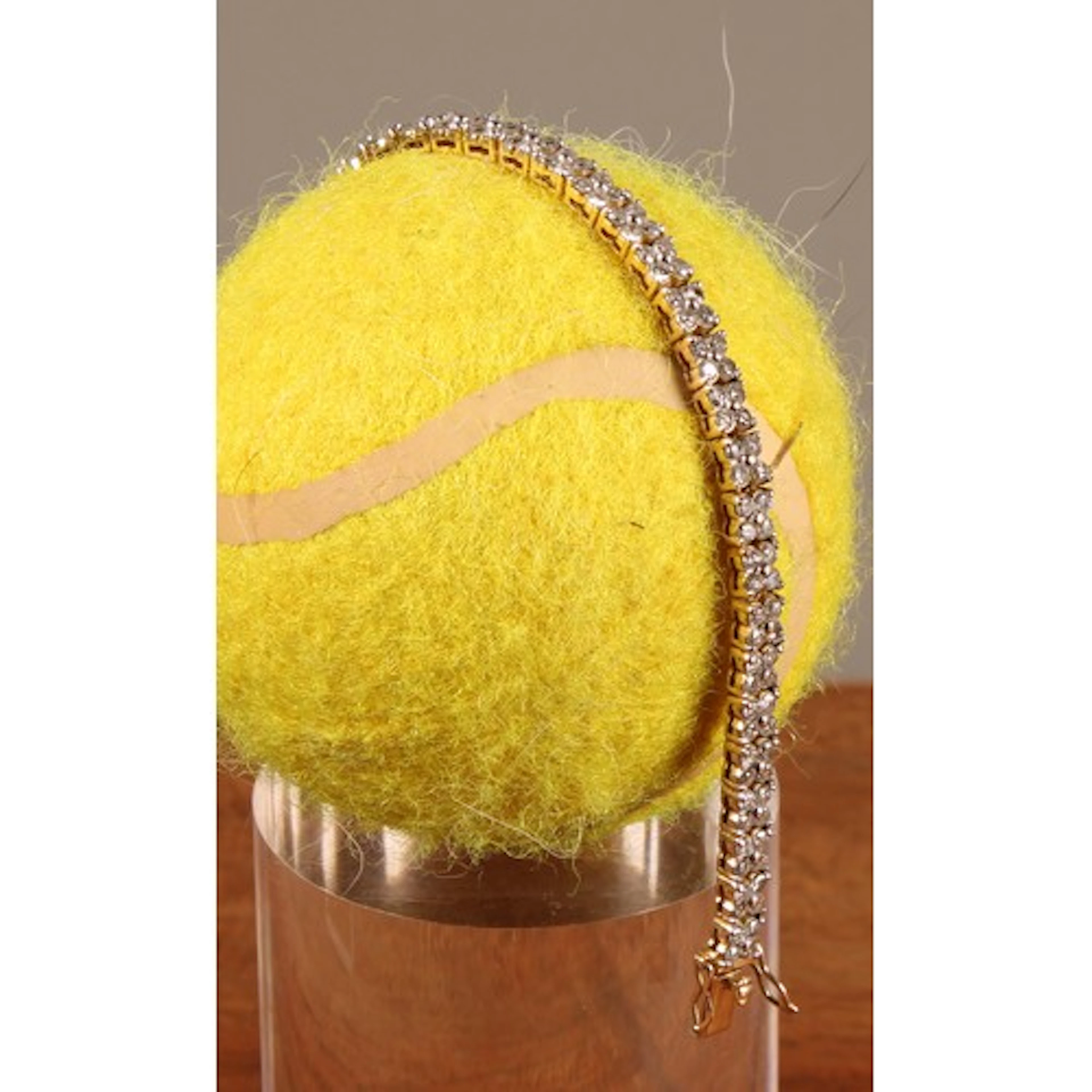 A diamond tennis bracelet, composed of thirty six four stone...