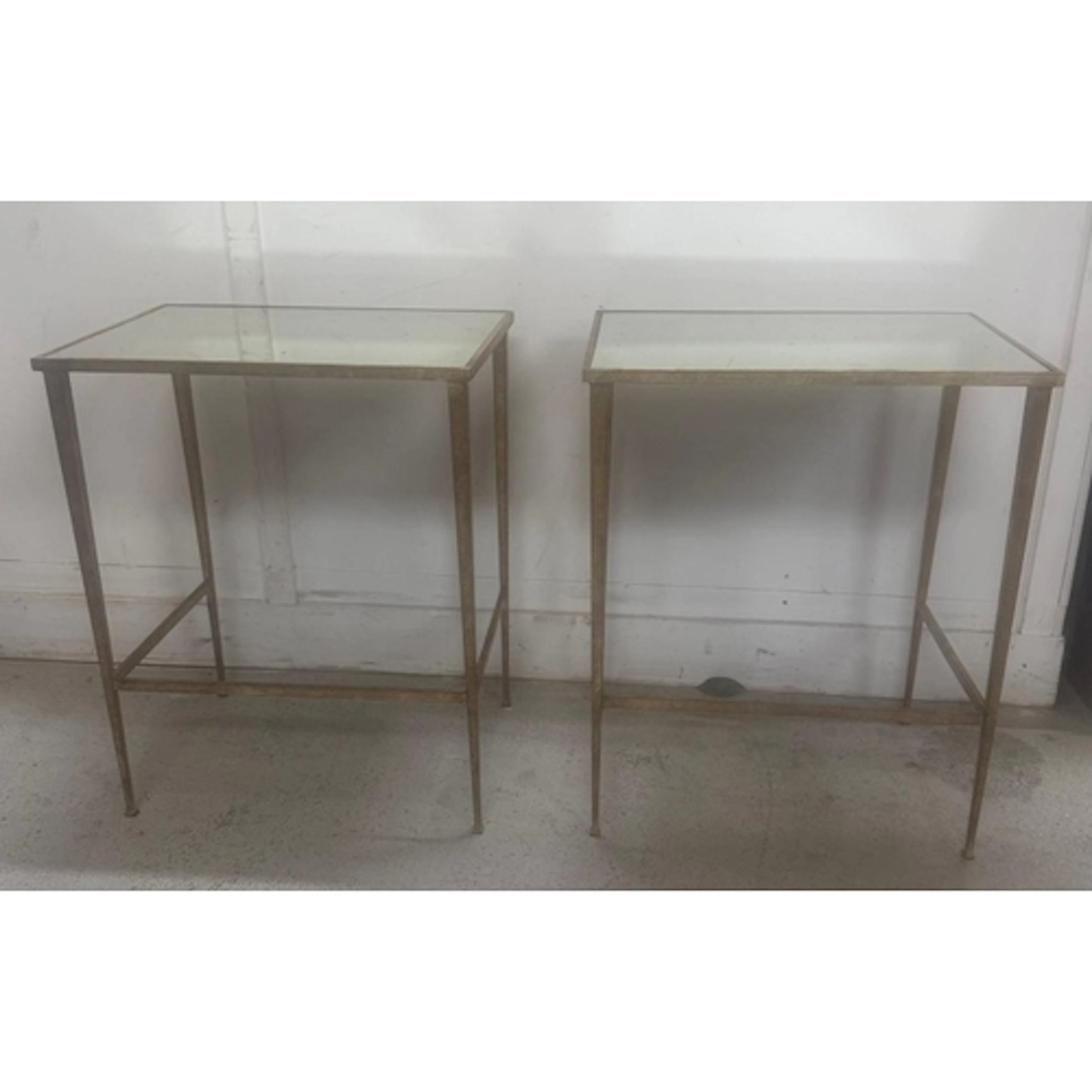 A pair or wrought iron gold painted side tables with mirrore...