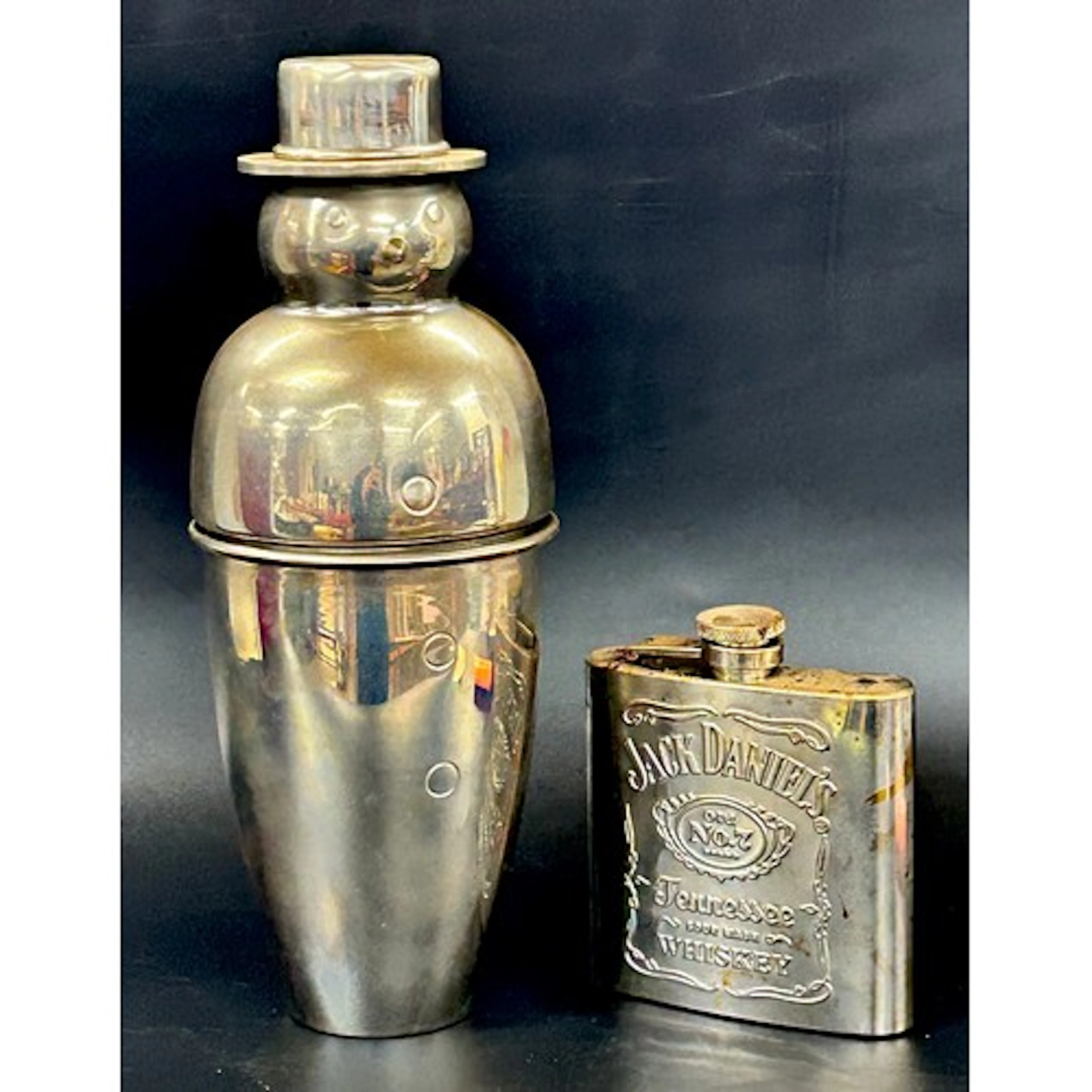 A Jack Daniels hip flask and a cocktail shaker in the form o...