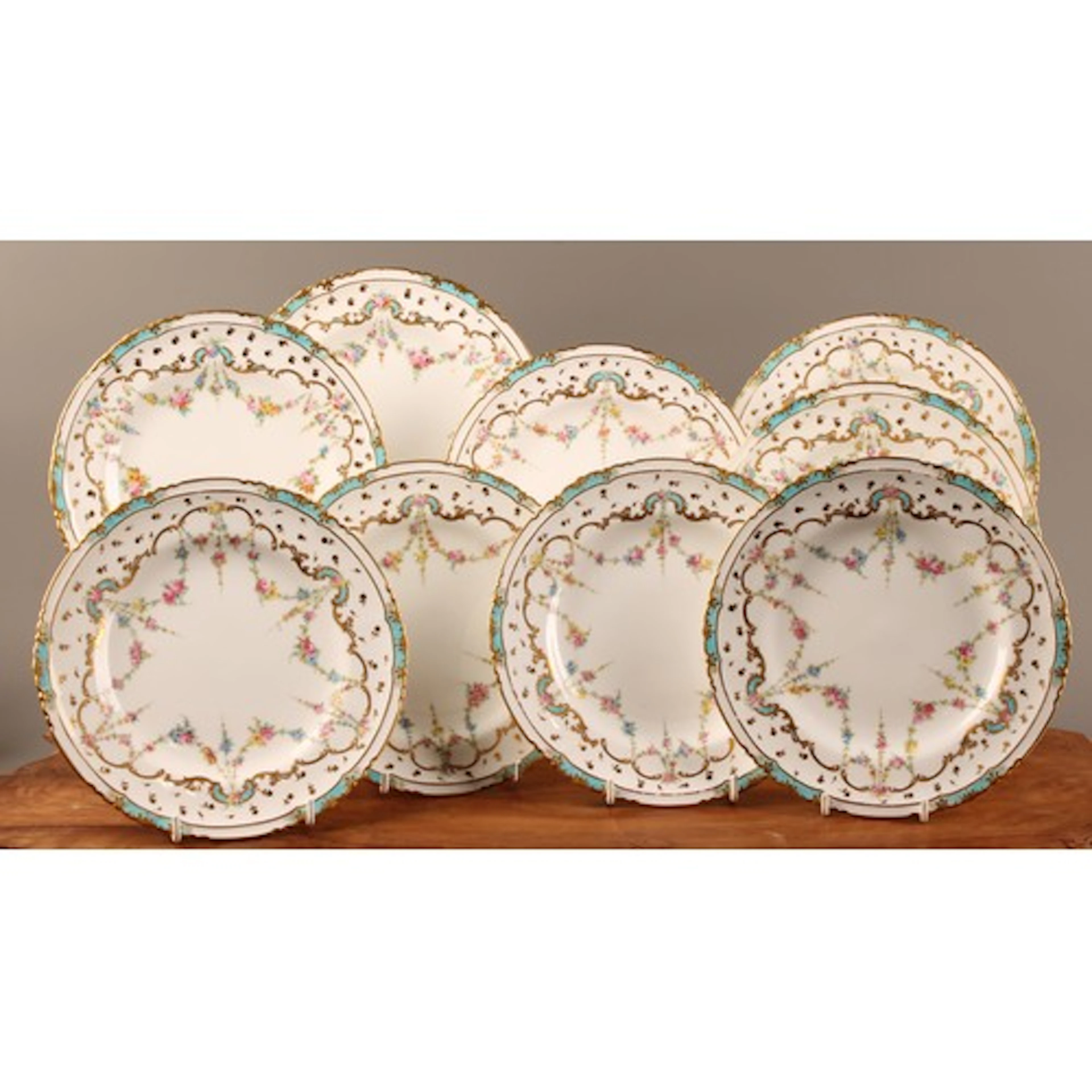 A set of nine Royal Crown Derby shaped circular dessert plat...