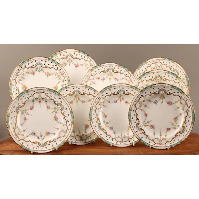 A set of nine Royal Crown Derby shaped circular dessert plat...