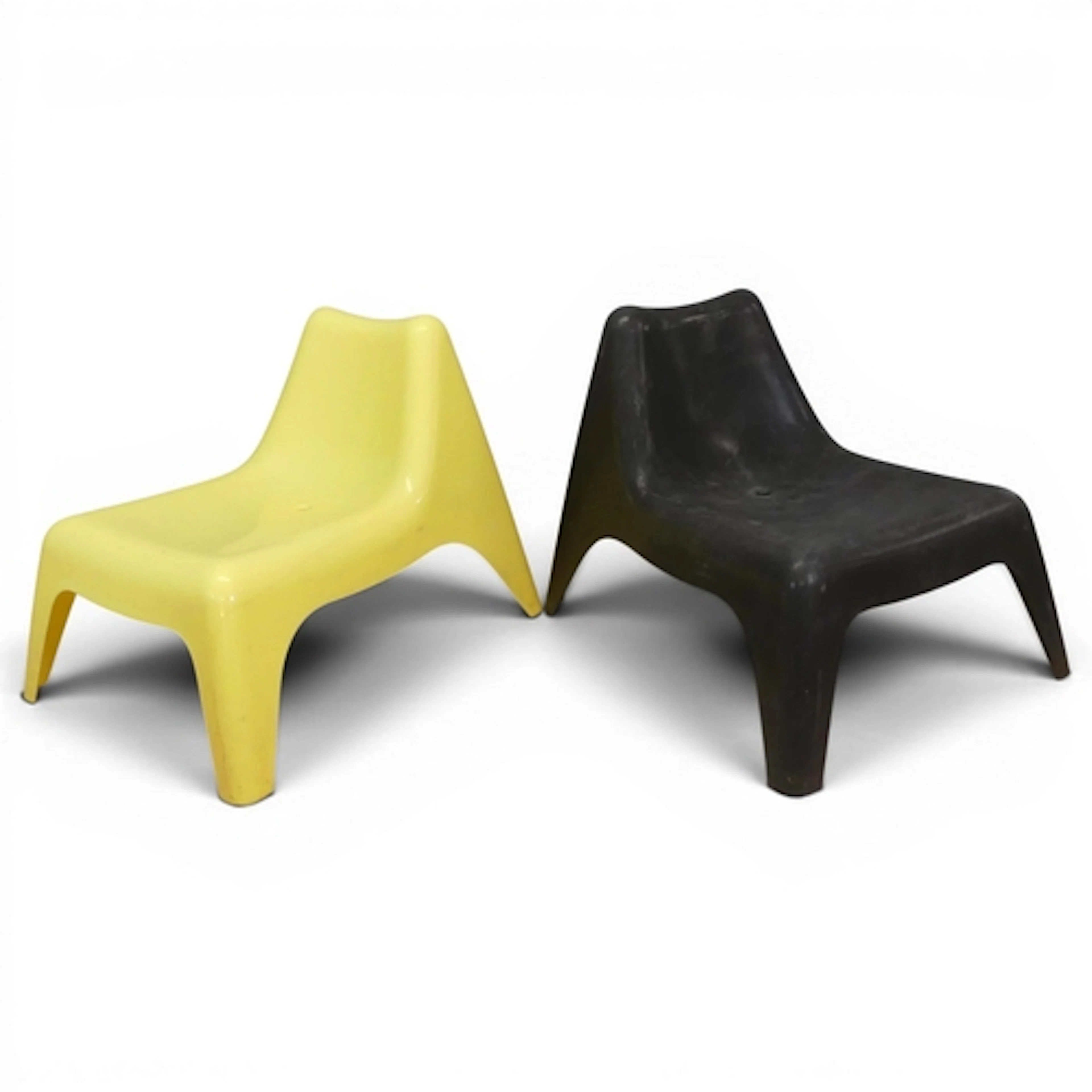 A pair of moulded plastic stacking chairs in the manner of T...