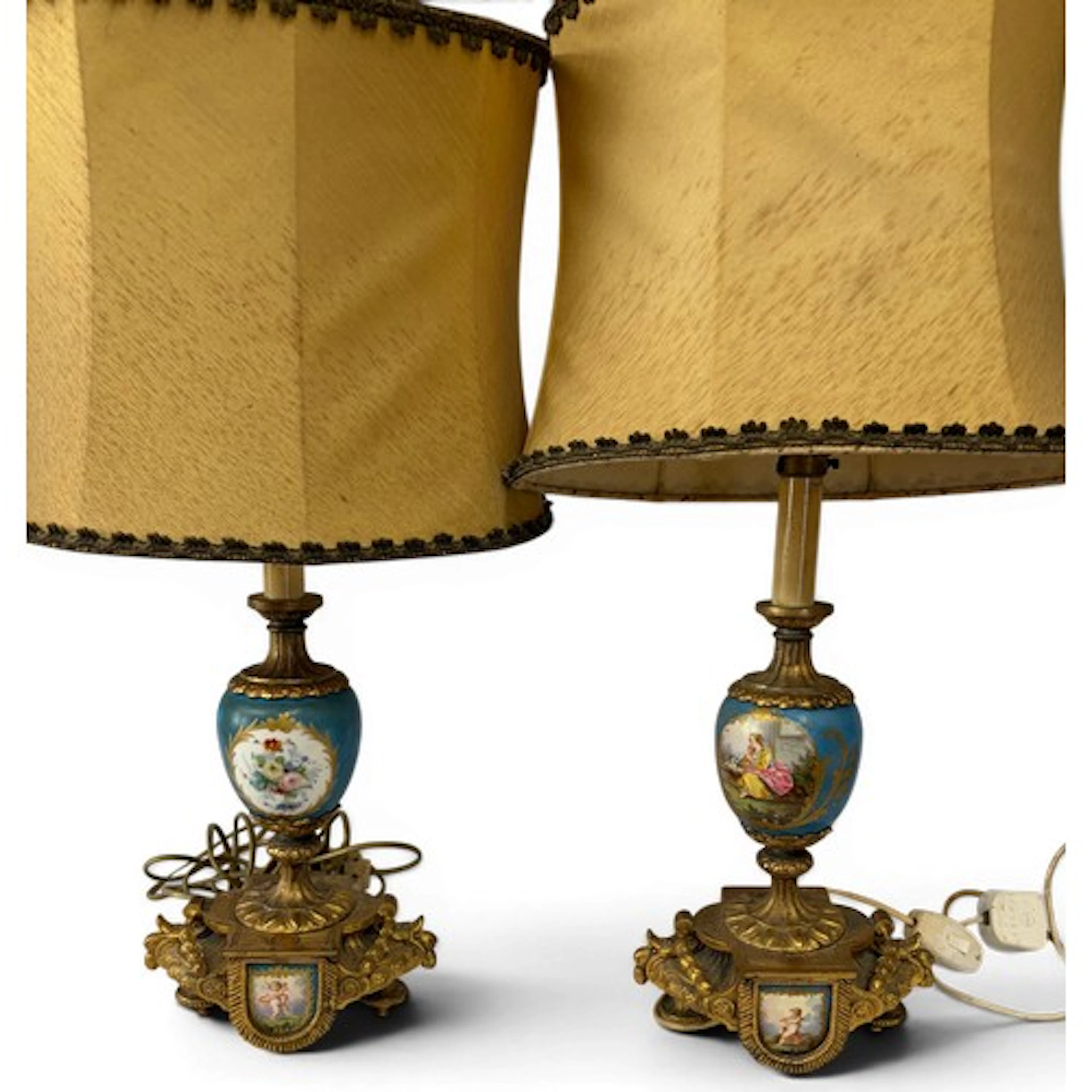 A pair of French gilt spelter and hand painted porcelain ada...