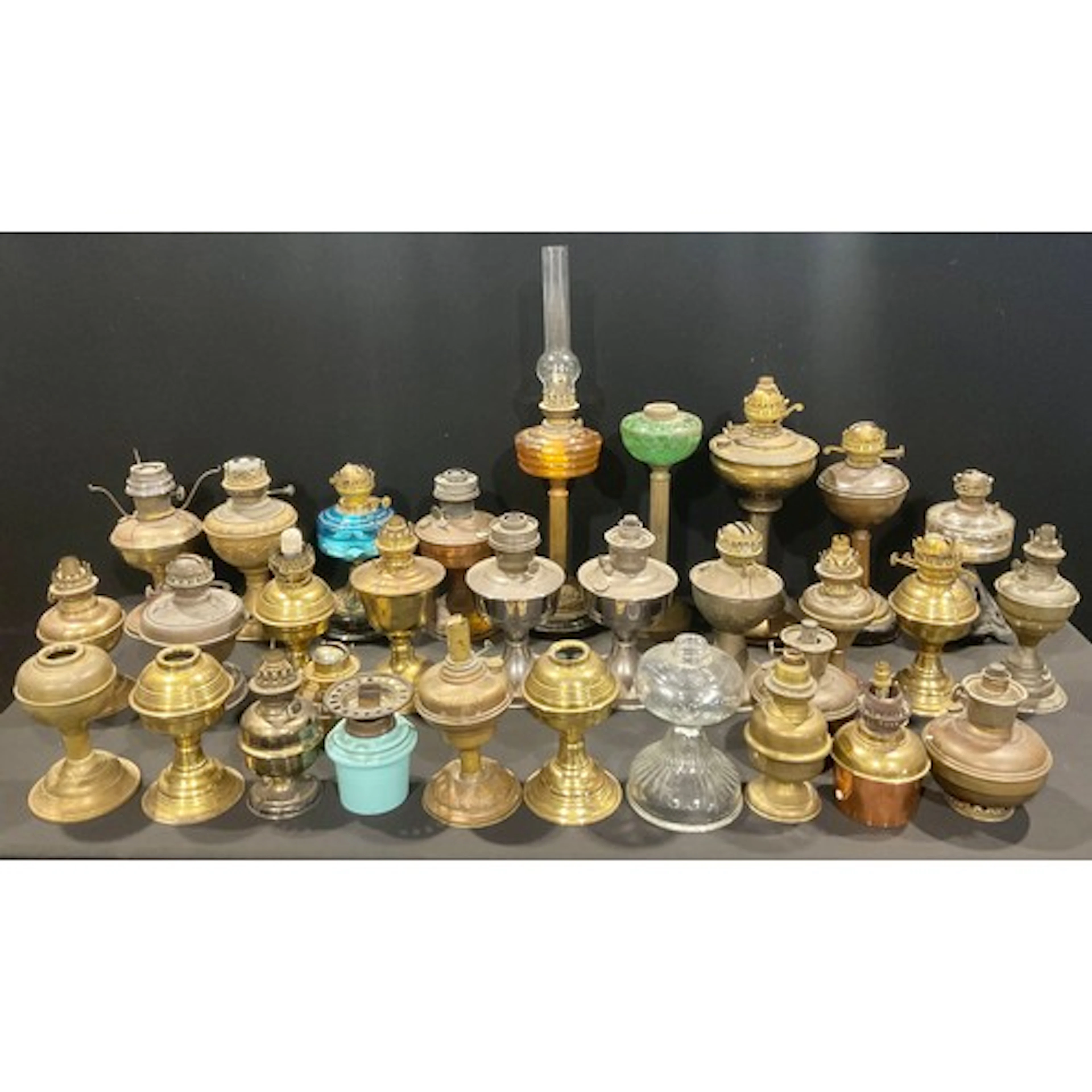 A collection of early 20th century and later oil lamps and p...