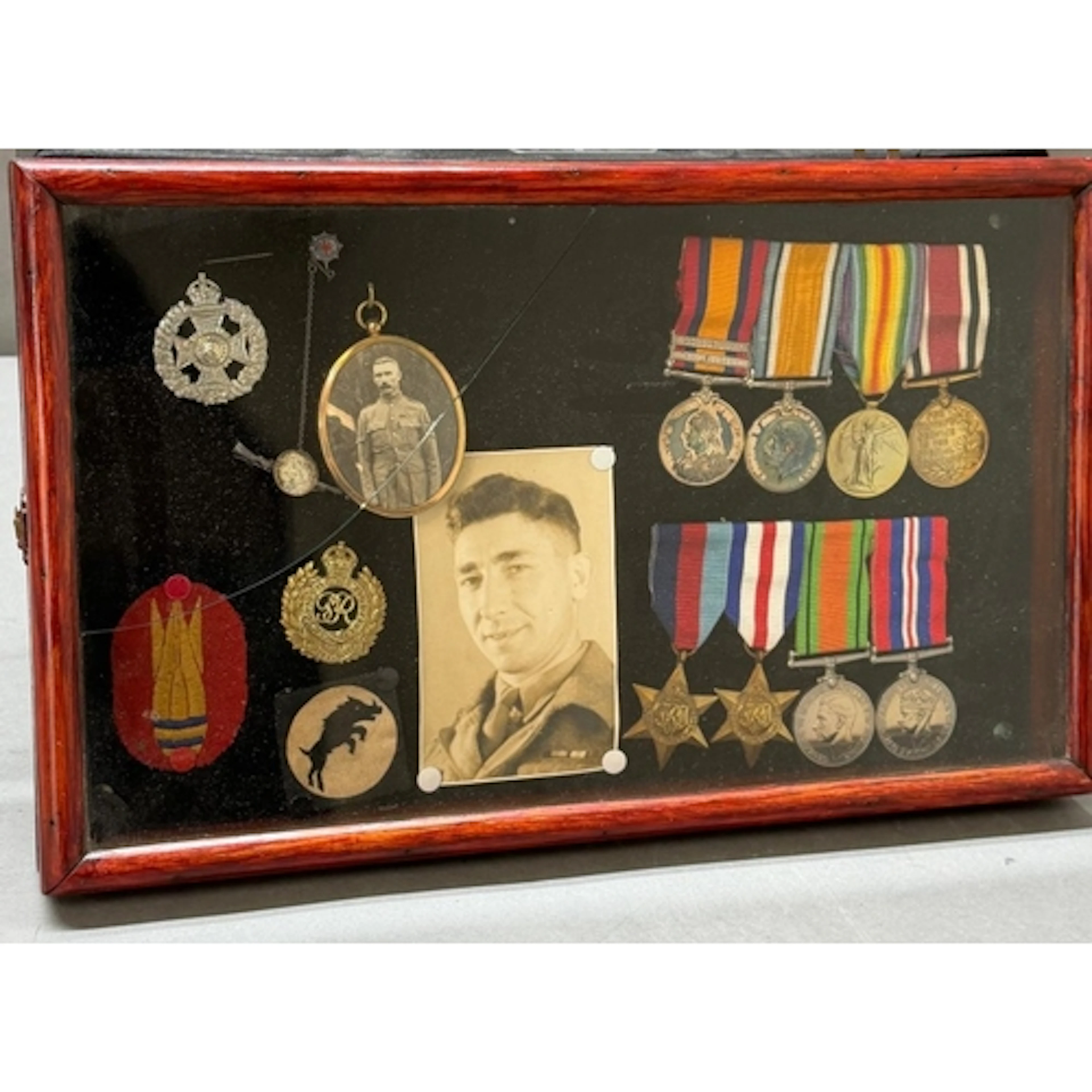 A cased selection of medals and military mementos starting w...