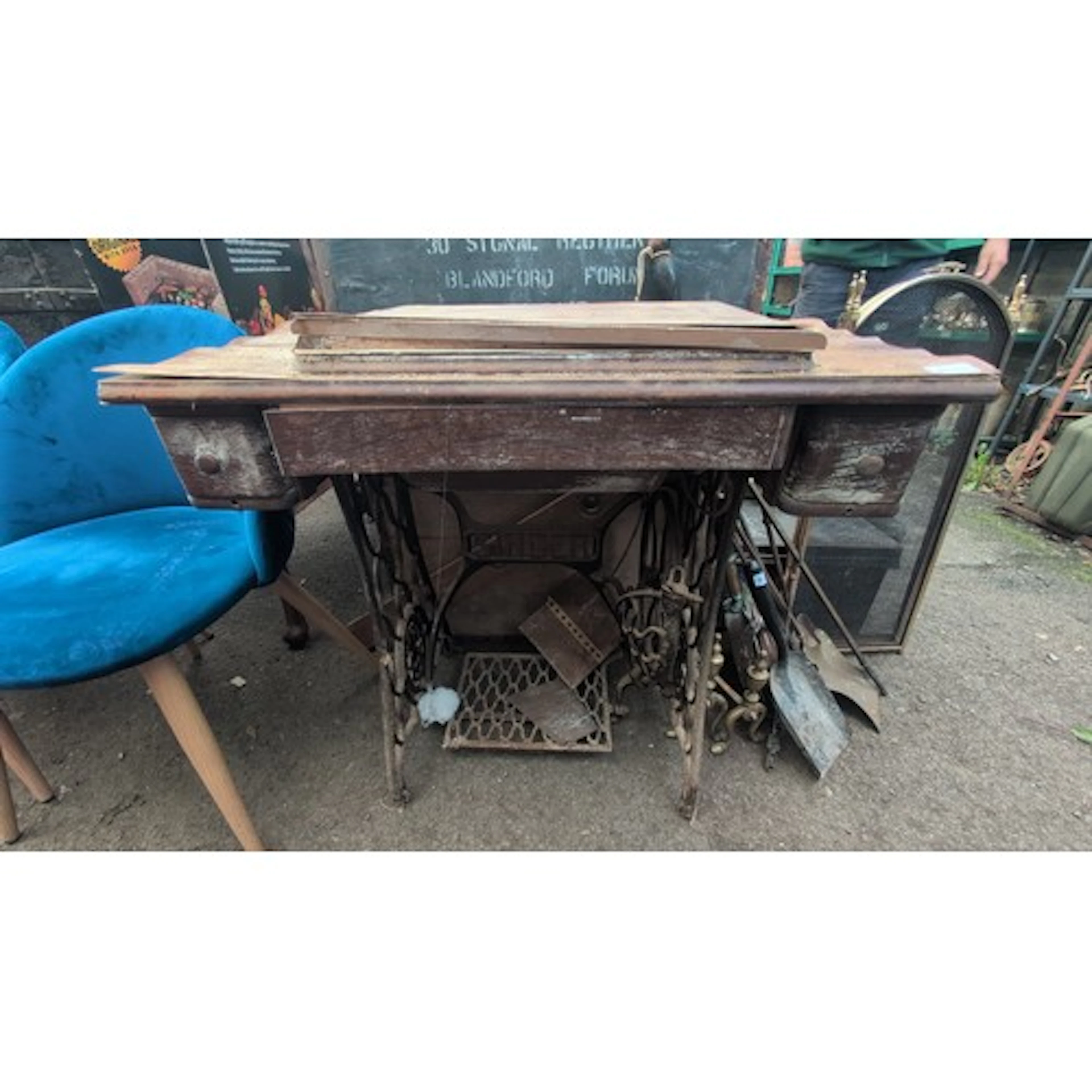Singer treadle sewing machine in a rectangular oak cabinet