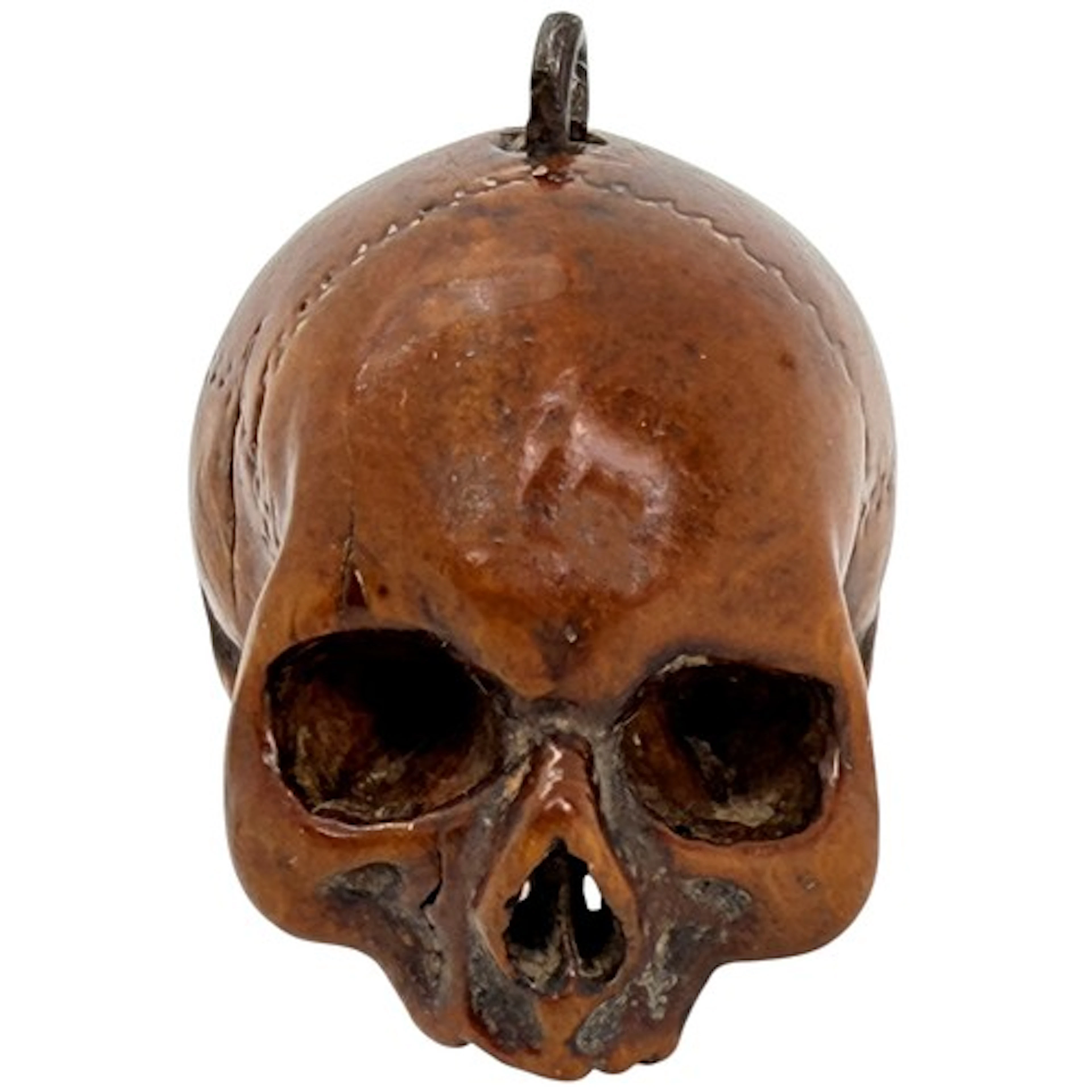 A finely carved boxwood pendant bead in the form of a human ...