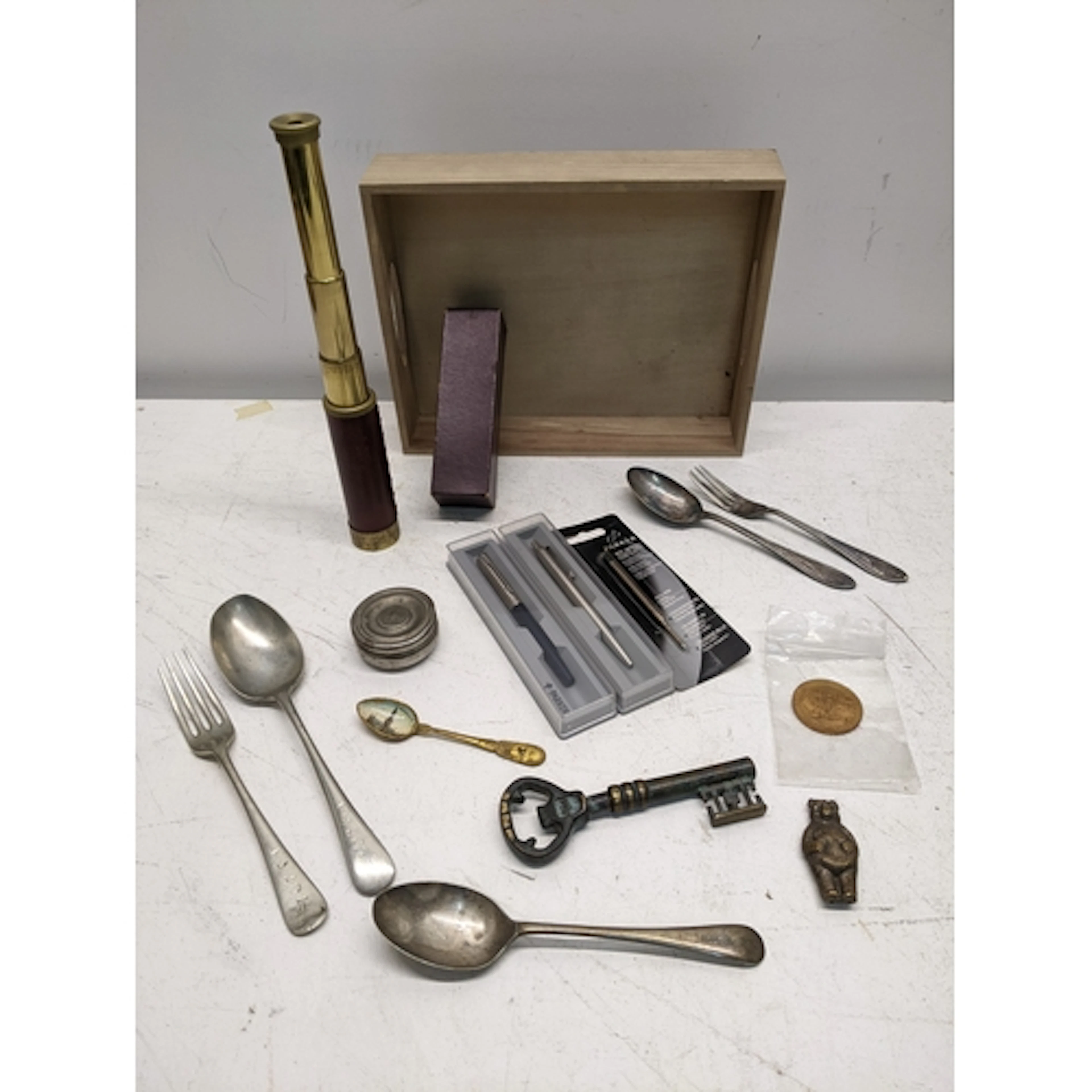 Small wooden tray containing various items to include a Navy...