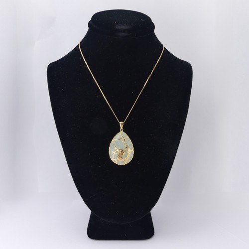 A 14ct gold mounted Jade Pendant, the pear shaped pale greed...