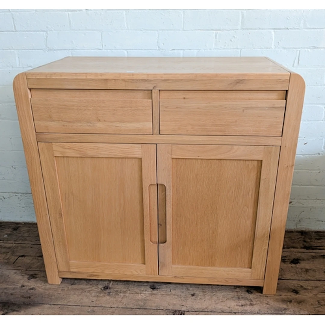 A small modern light oak finished sideboard fitted two drawe...