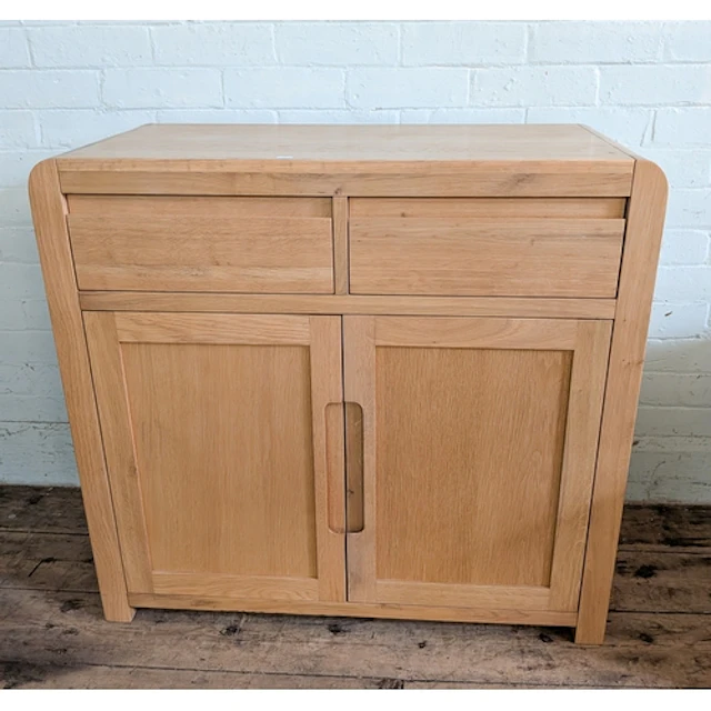A small modern light oak finished sideboard fitted two drawe...