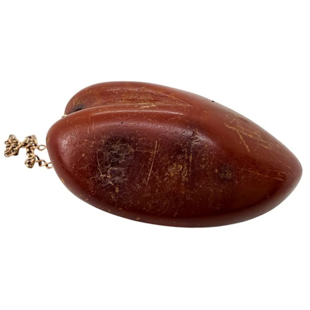 A substantial heart shaped carved amber pendant or romantic ...