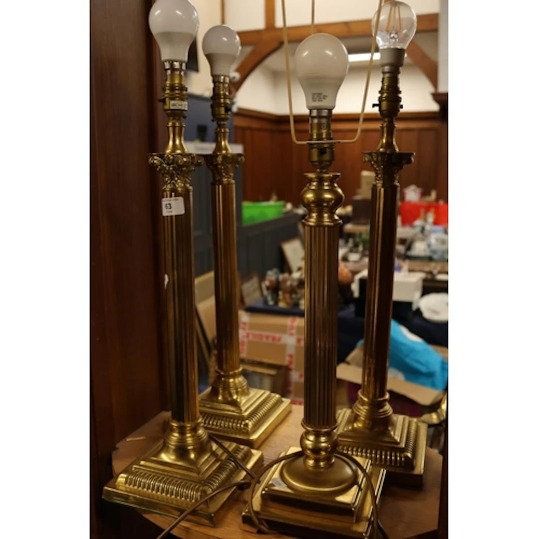 Three brass Corinthian column lamps, and another. (4)