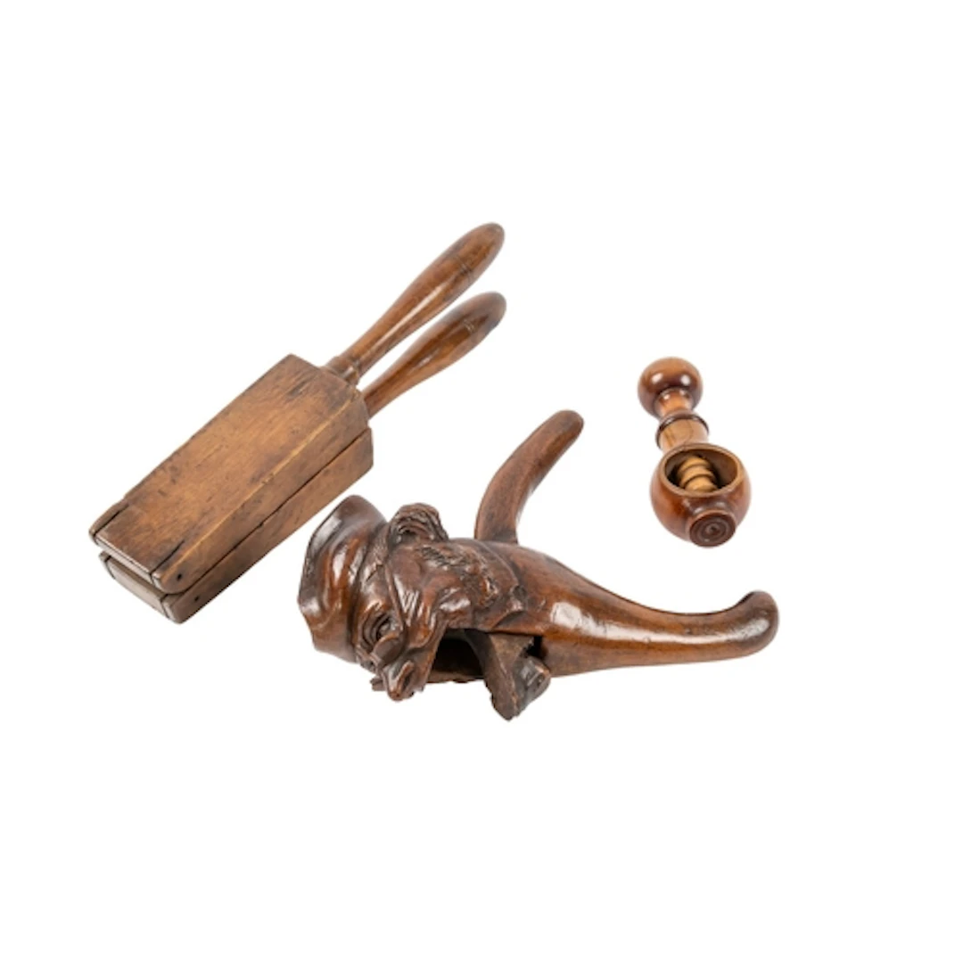 A carved and stained treen nutcracker in the form of a caric...