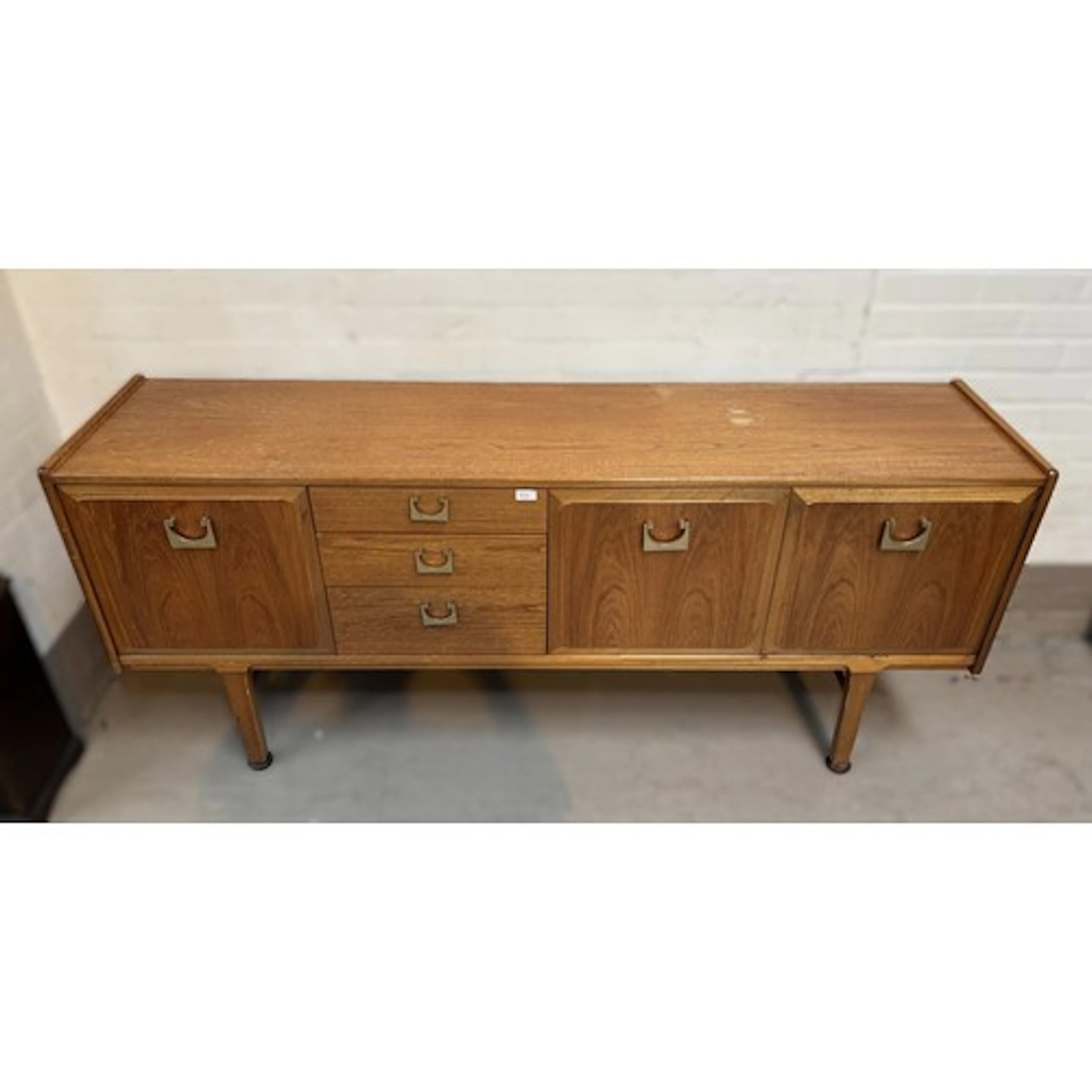 A mid 20th century Nathan teak sideboard with cupboards, cen...