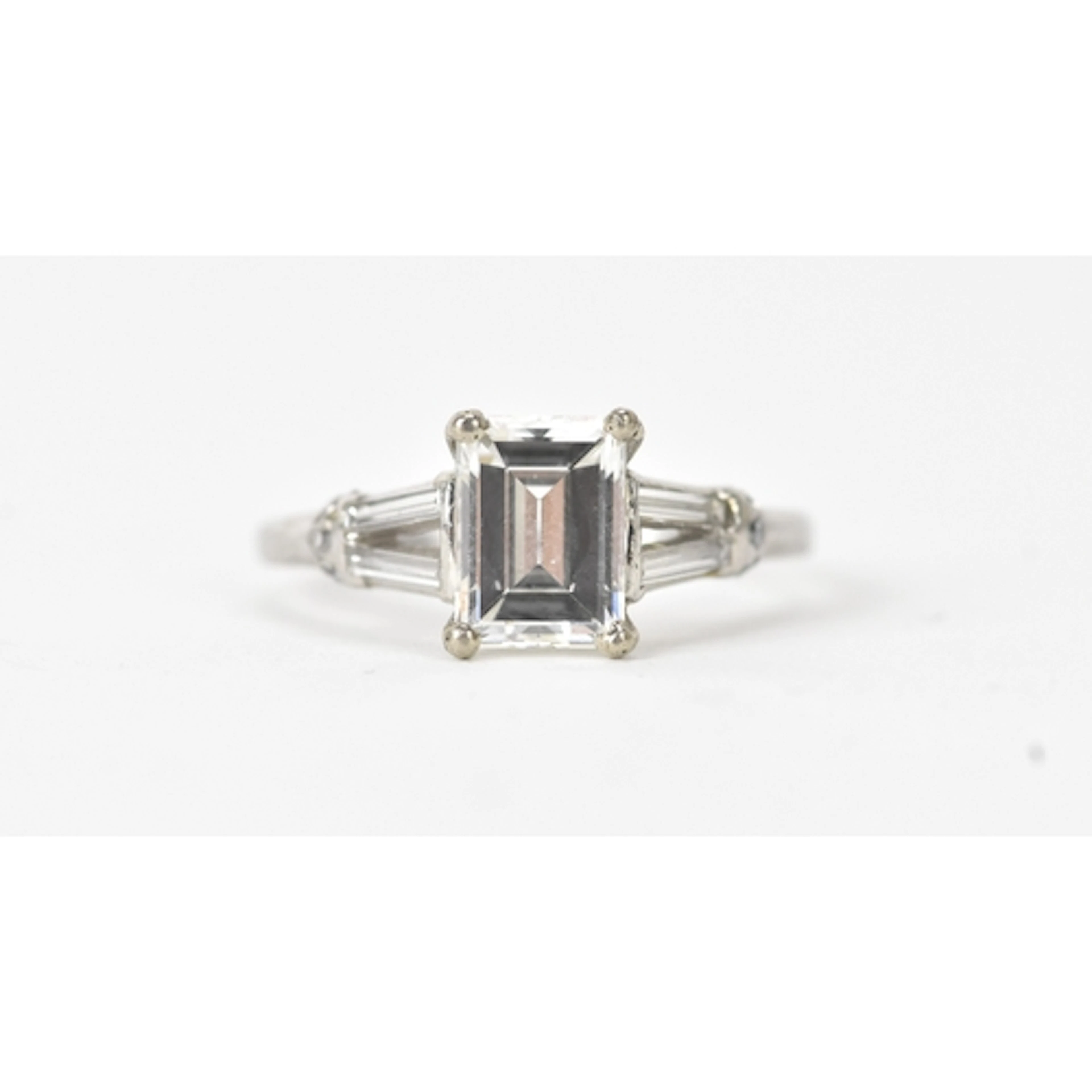 A 1.47ct baguette cut diamond engagement ring, with De Beers...
