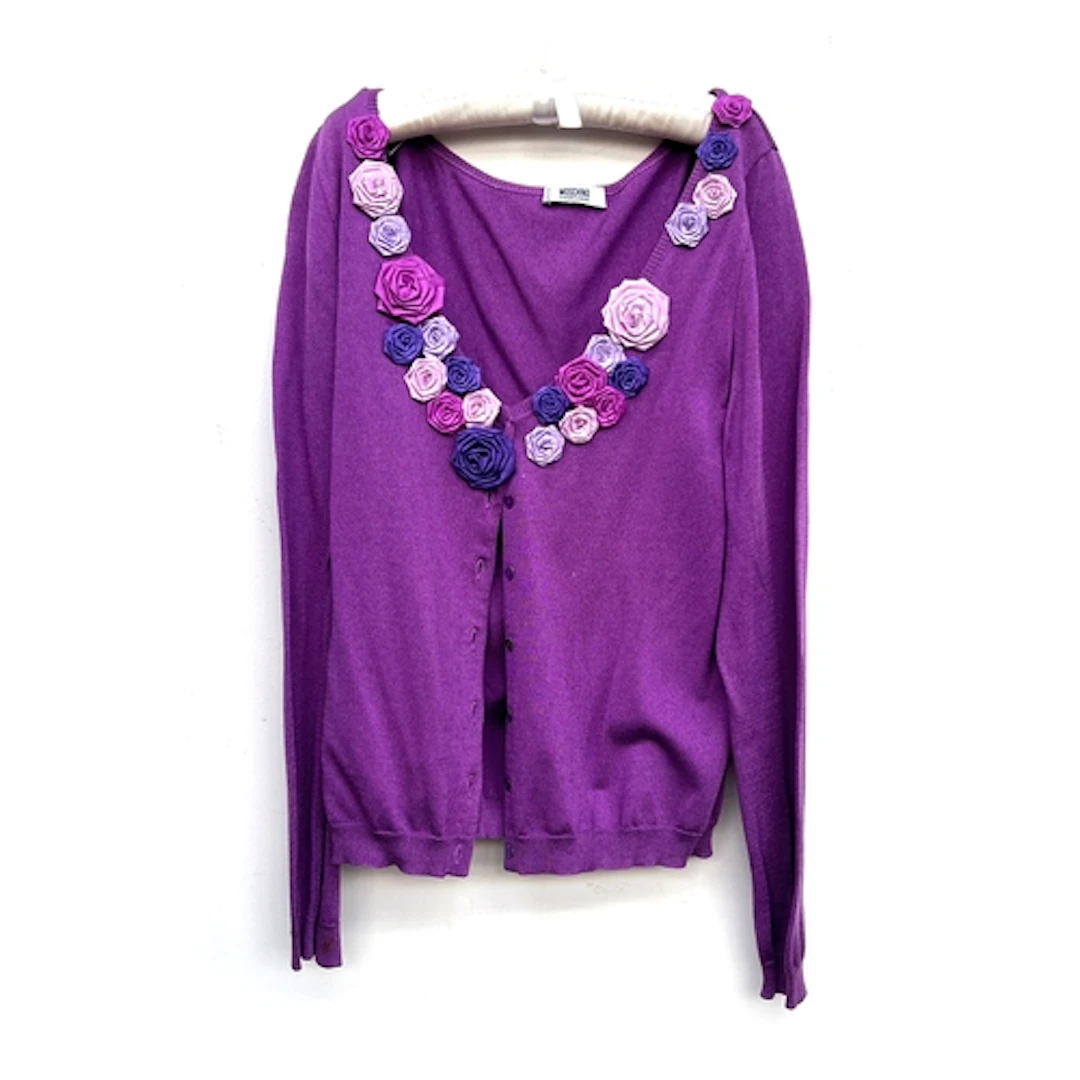 Three Moschino tops: a cotton blend purple cardigan with app...