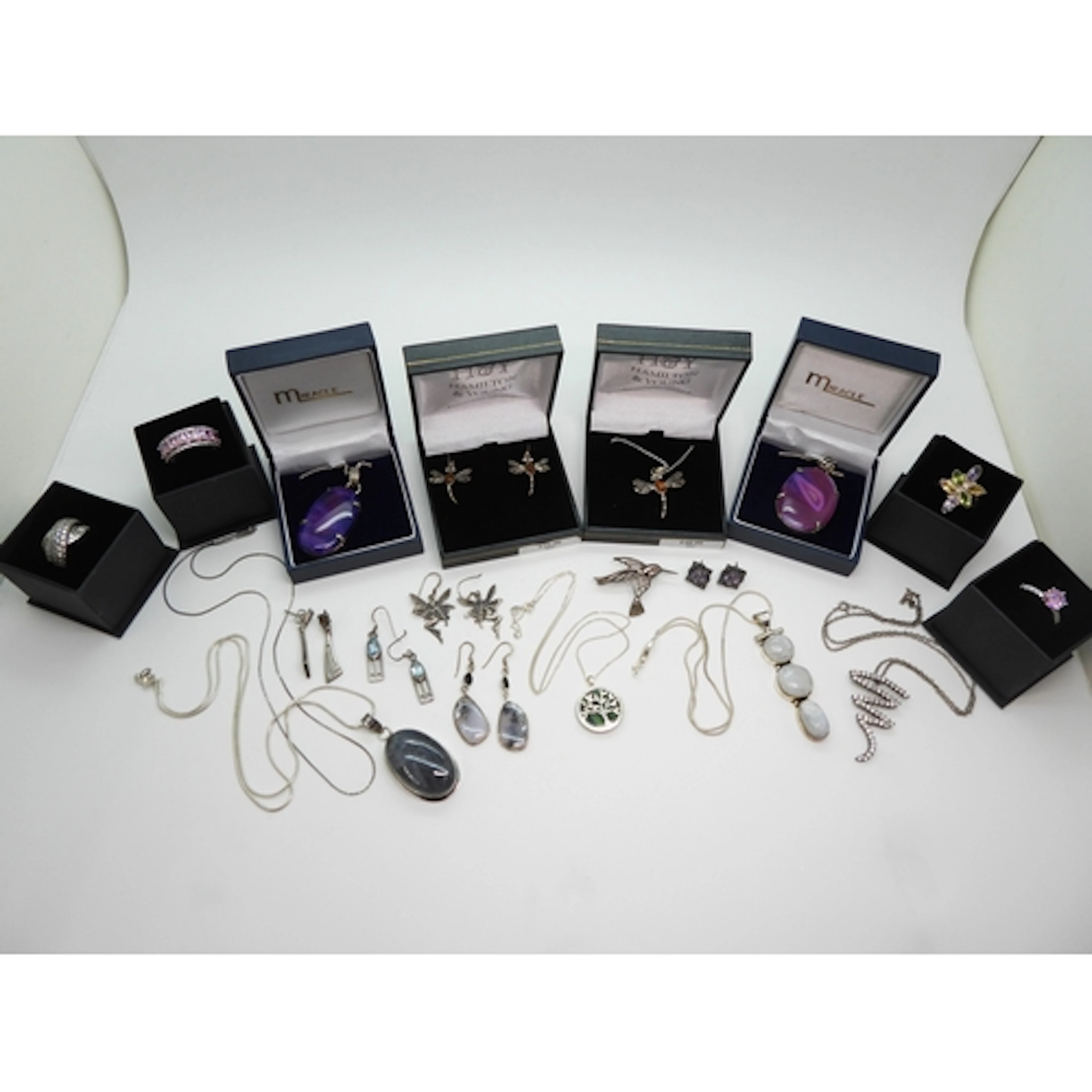 A silver moonstone pendant and chain, further pendants set w...