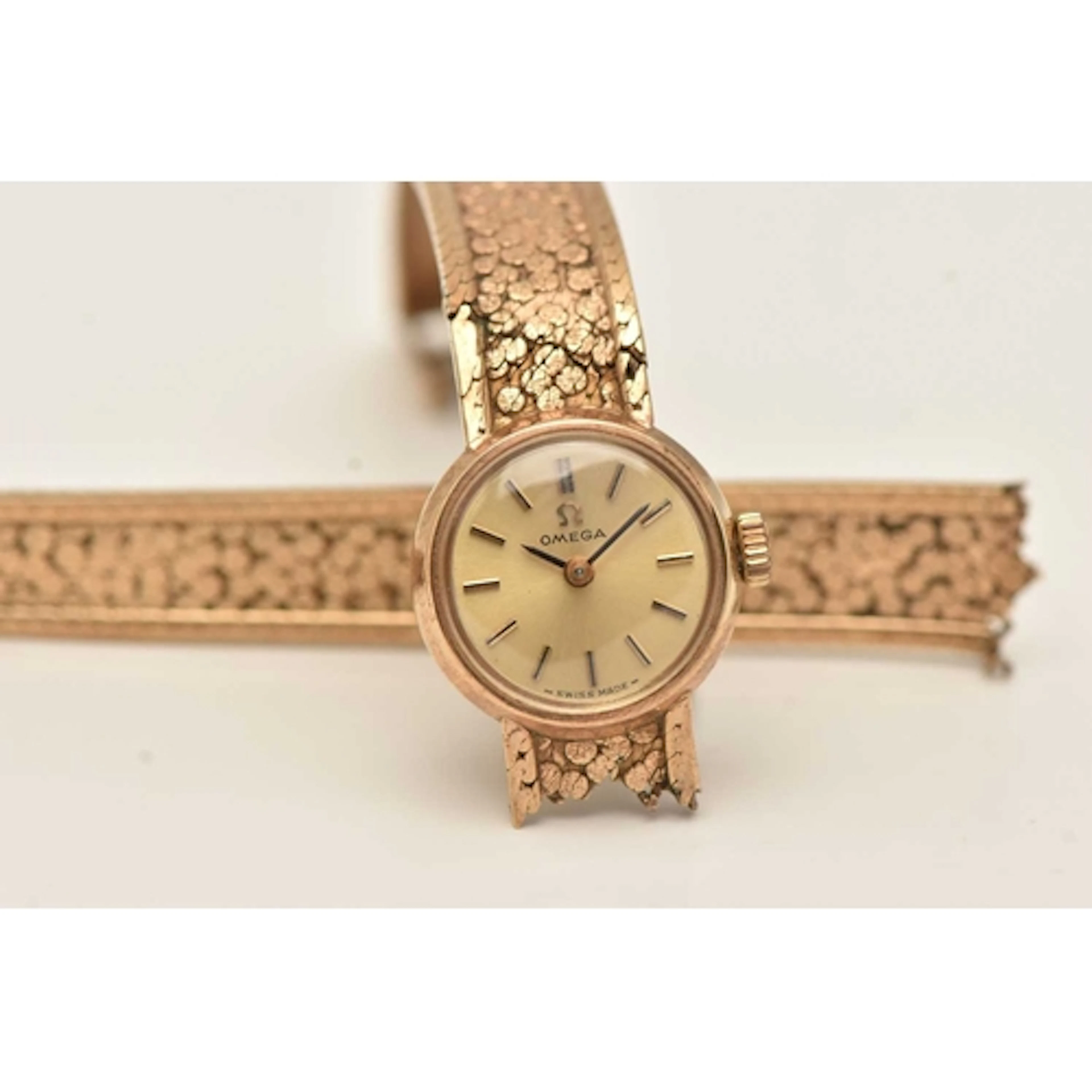 A 9CT YELLOW GOLD 'OMEGA' WRISTWATCH, a ladies AF watch, han...