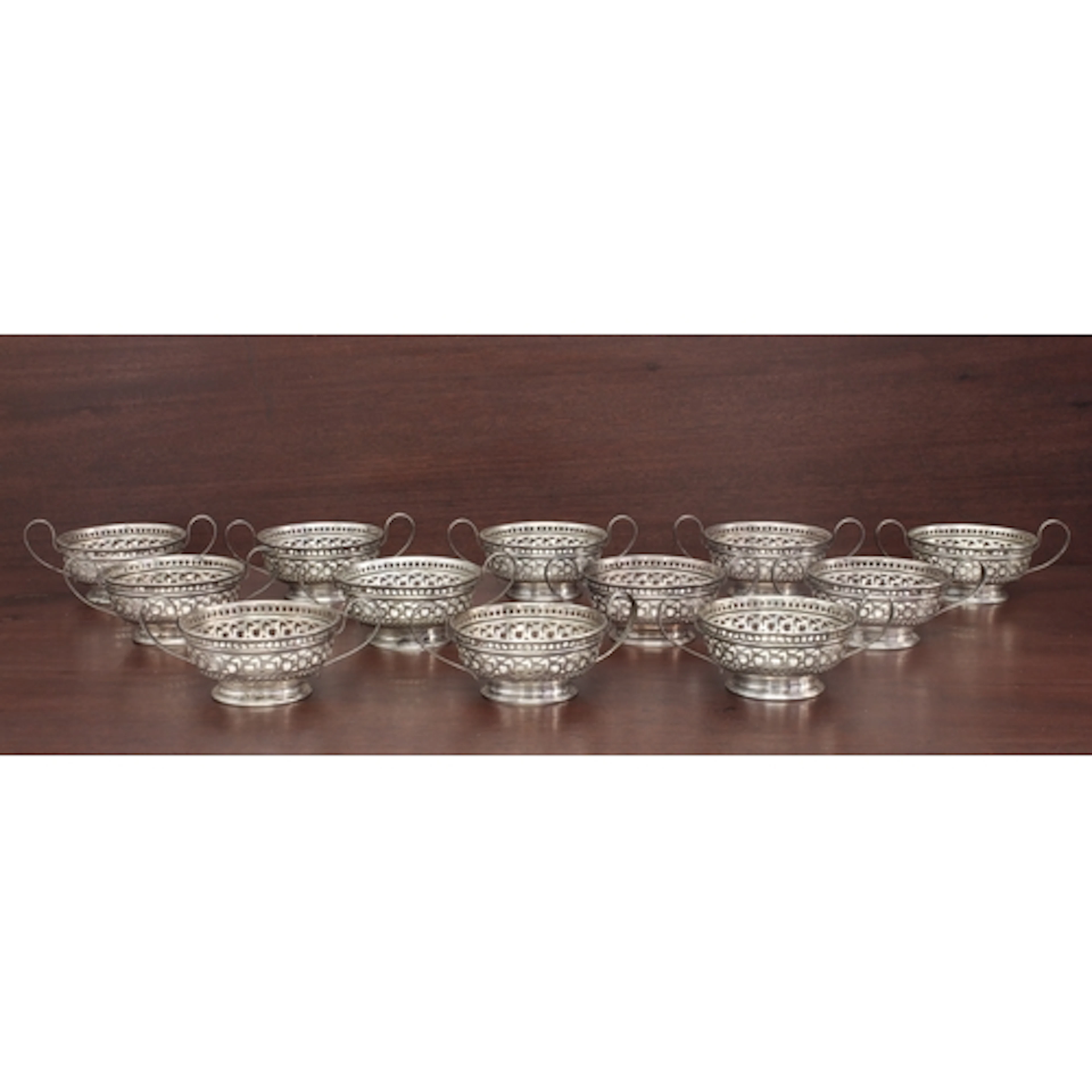 A set of twelve American pierced sterling silver two-handled...