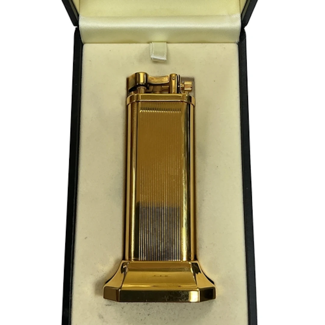 A Dunhill Arm Lift gold plated table lighter, stamped marks ...
