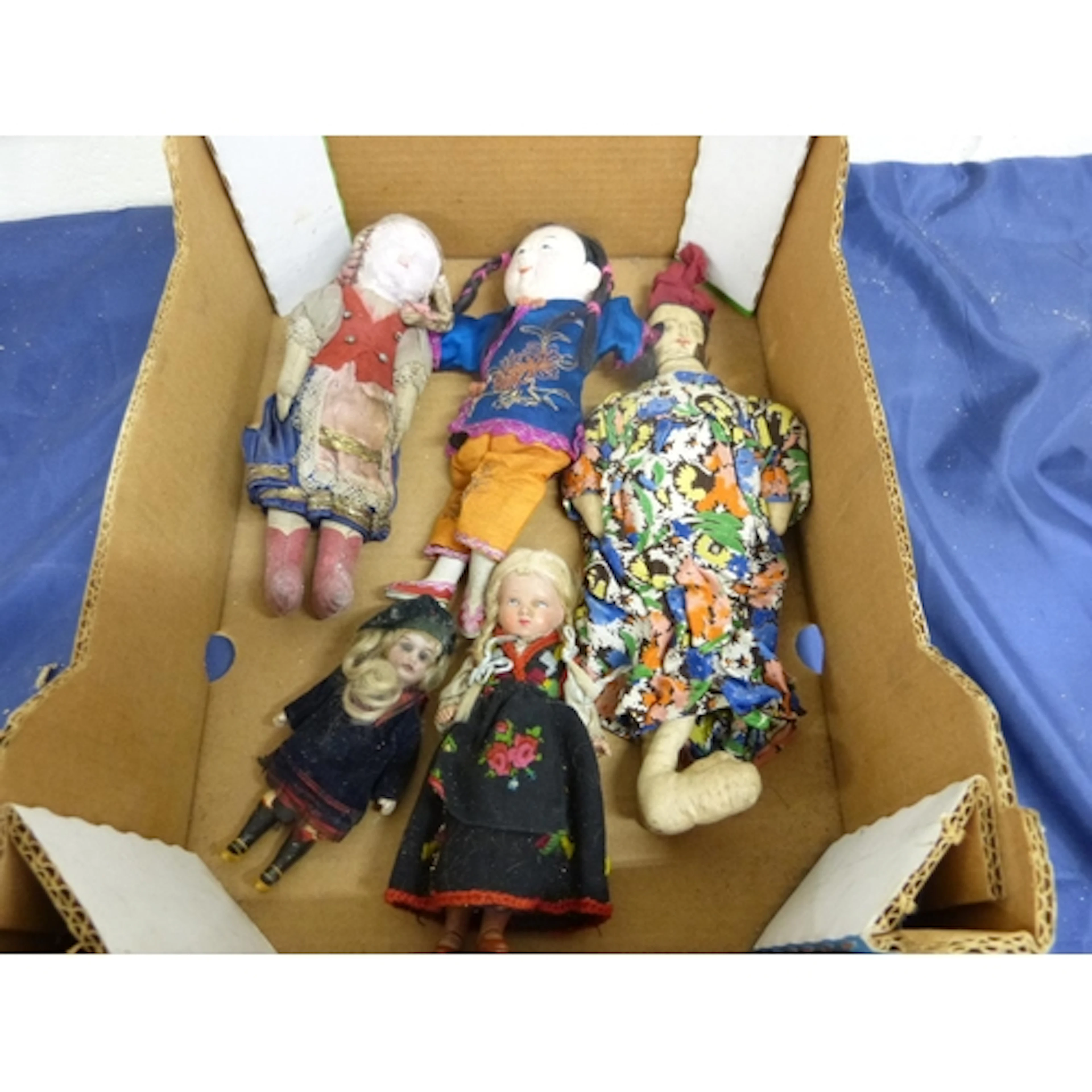 Box of antique world dolls to include China, Scotland etc.